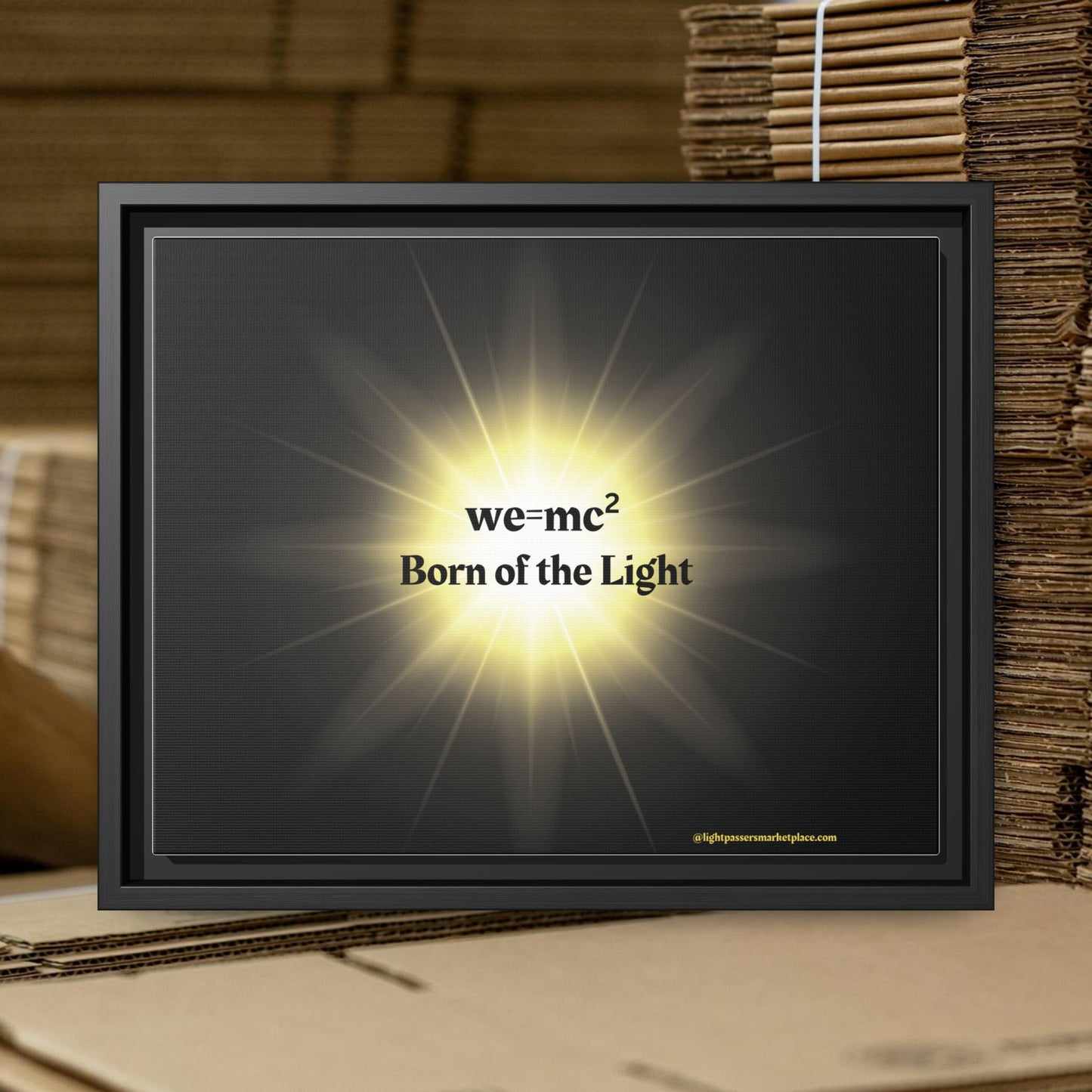 Inspirational Framed Canvas Art - we=mc² Born of the Light, showcasing a sleek black frame with a light accentuating its motivational design.