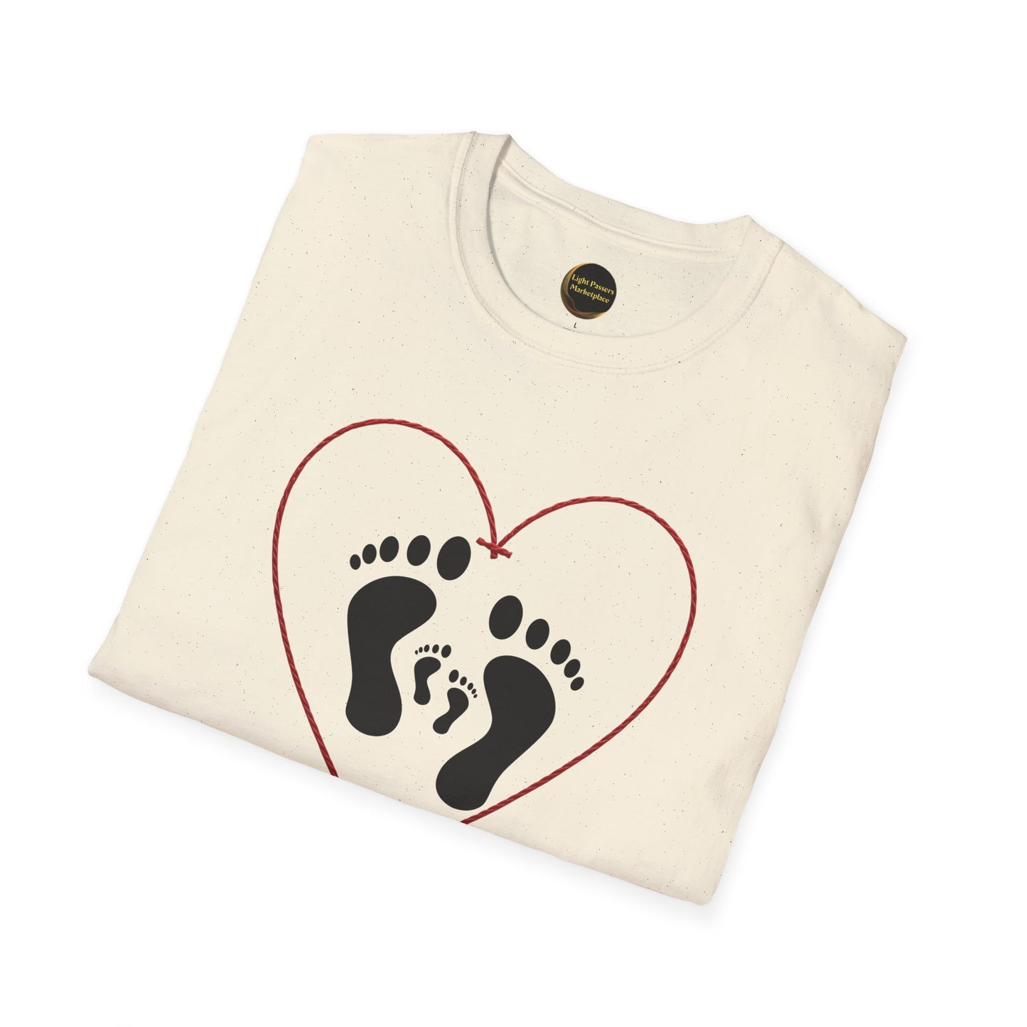 Folded Legacy Makers Unite T-Shirt featuring adult and child footprints within a red heart outline. Visible neck label in collar. Unisex, ethically made from ring-spun cotton.