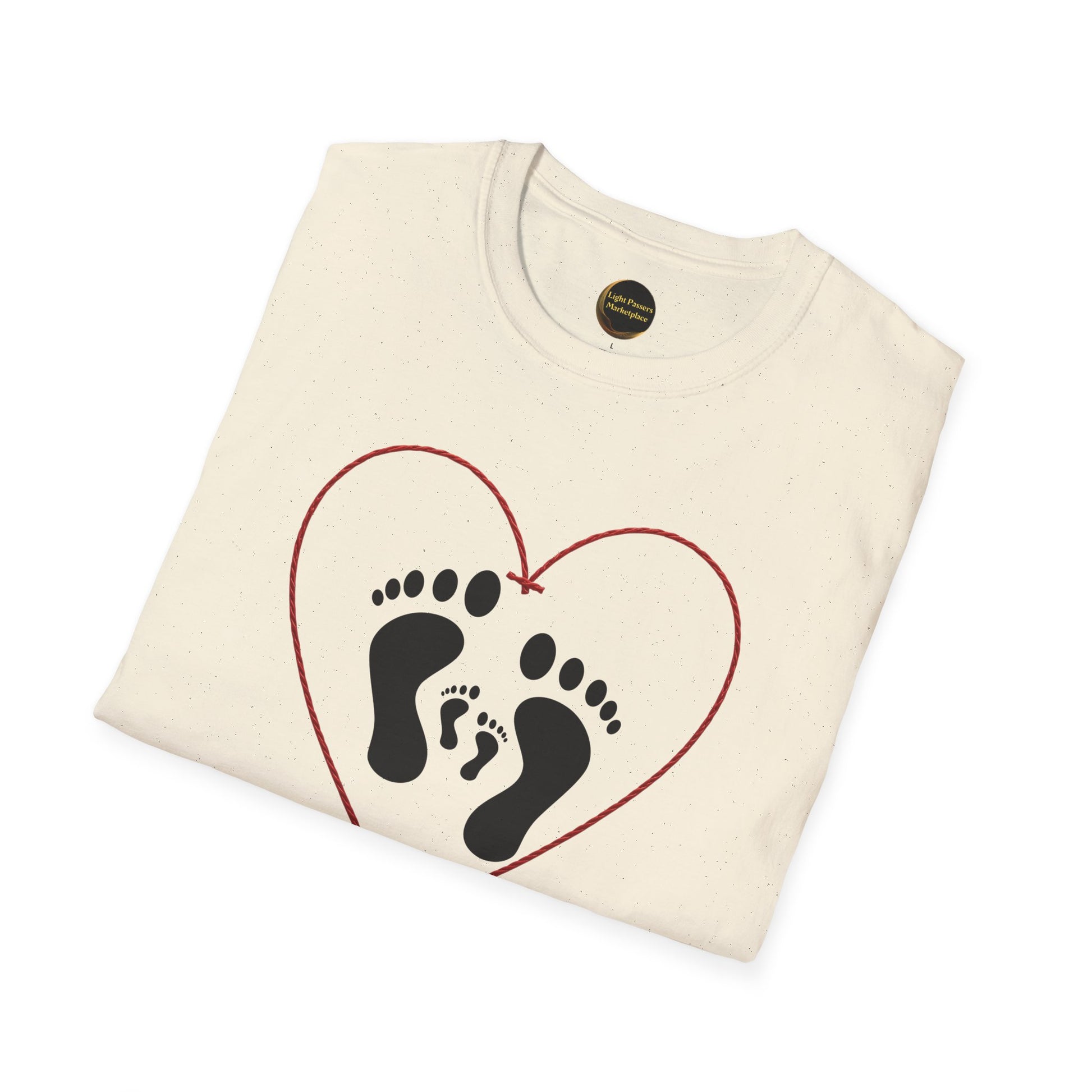 Folded Legacy Makers Unite T-Shirt featuring adult and child footprints within a red heart outline. Visible neck label in collar. Unisex, ethically made from ring-spun cotton.