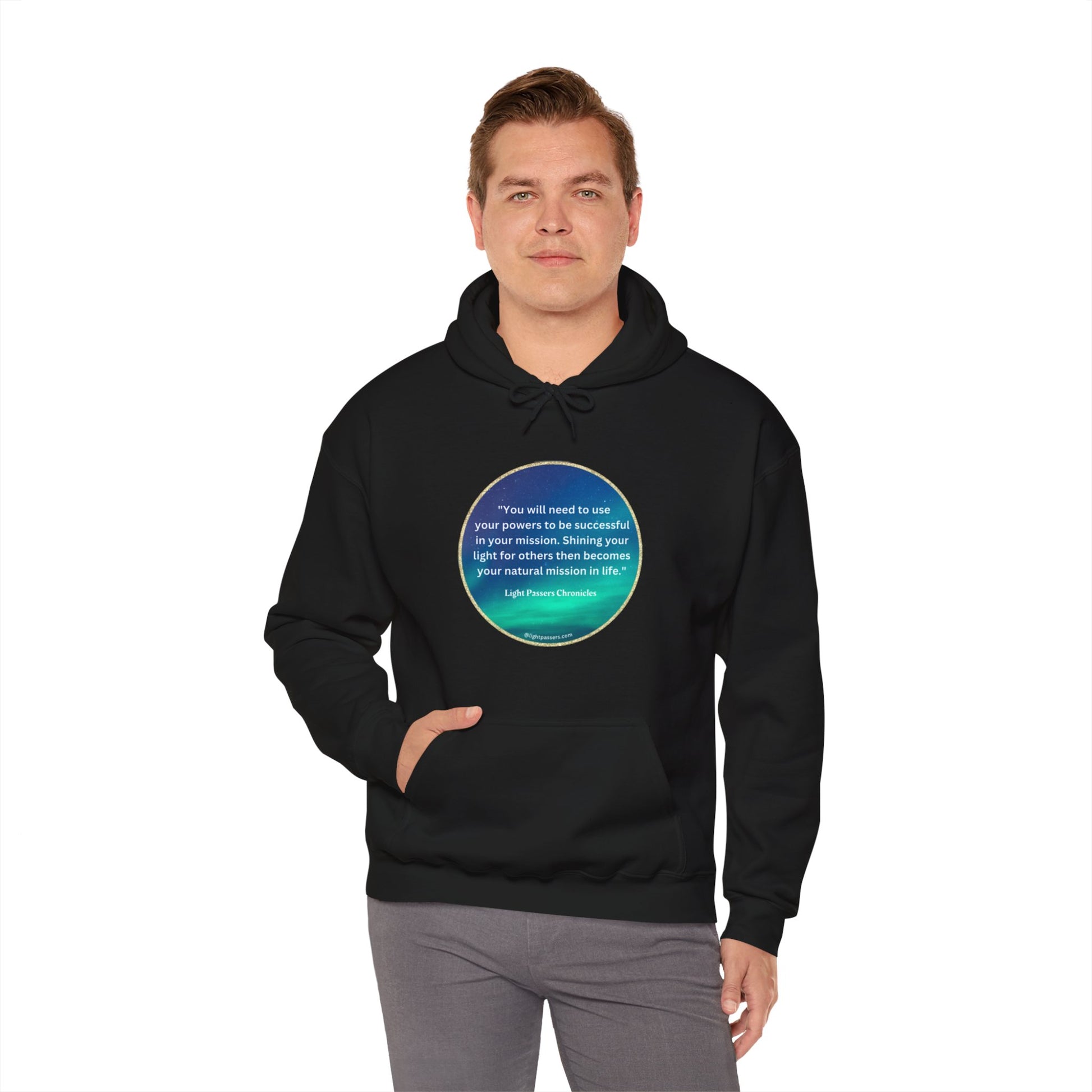 A person in a black hooded sweatshirt with a blue circle and white text, featuring a kangaroo pocket and color-matched drawstring. Made of 50% cotton and 50% polyester for warmth and comfort.