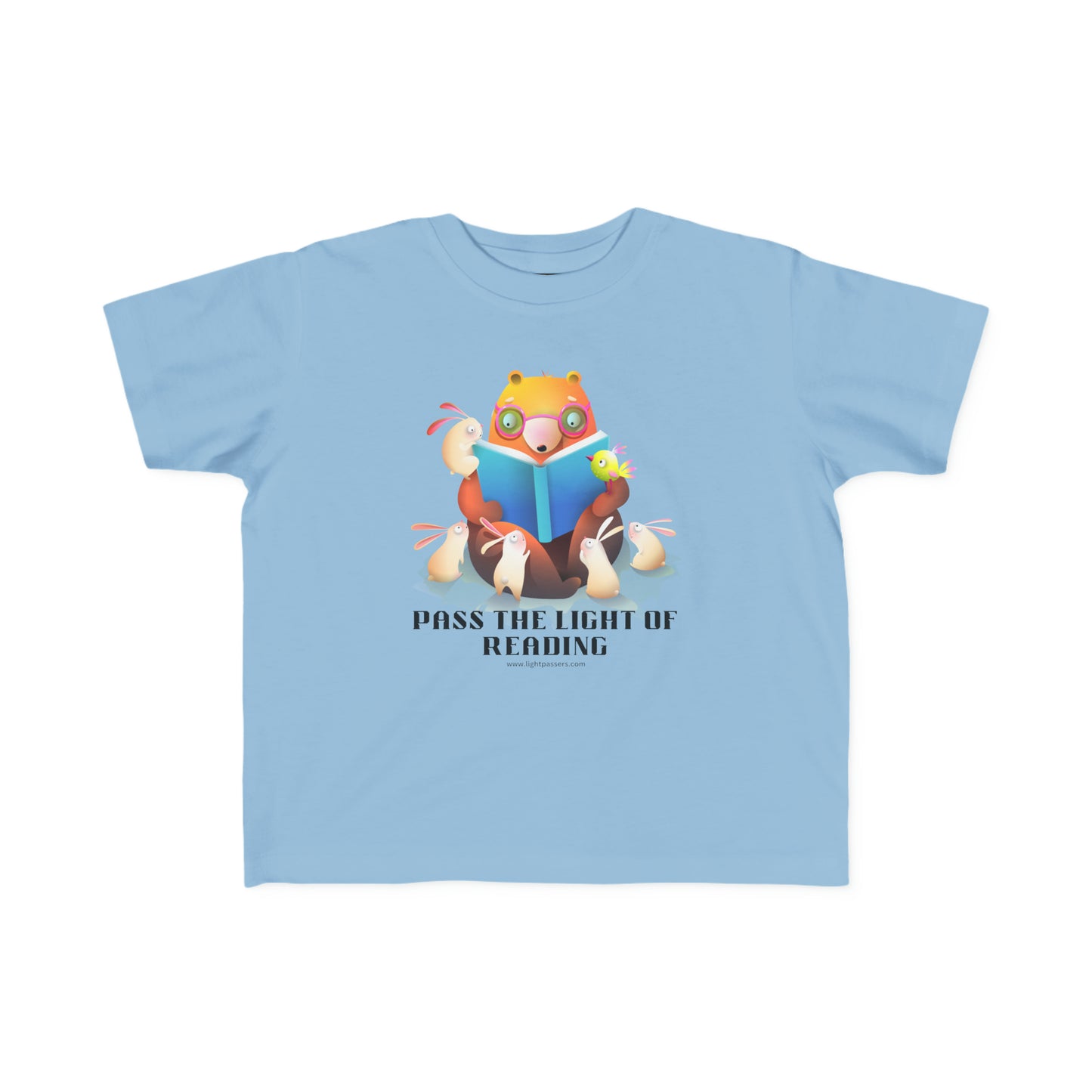 A Pass the Light of Reading Toddler T-shirt featuring cartoon characters, a bear reading a book, and a cartoon rabbit. Made of 100% combed cotton, light fabric, and tear-away label, ideal for sensitive skin.