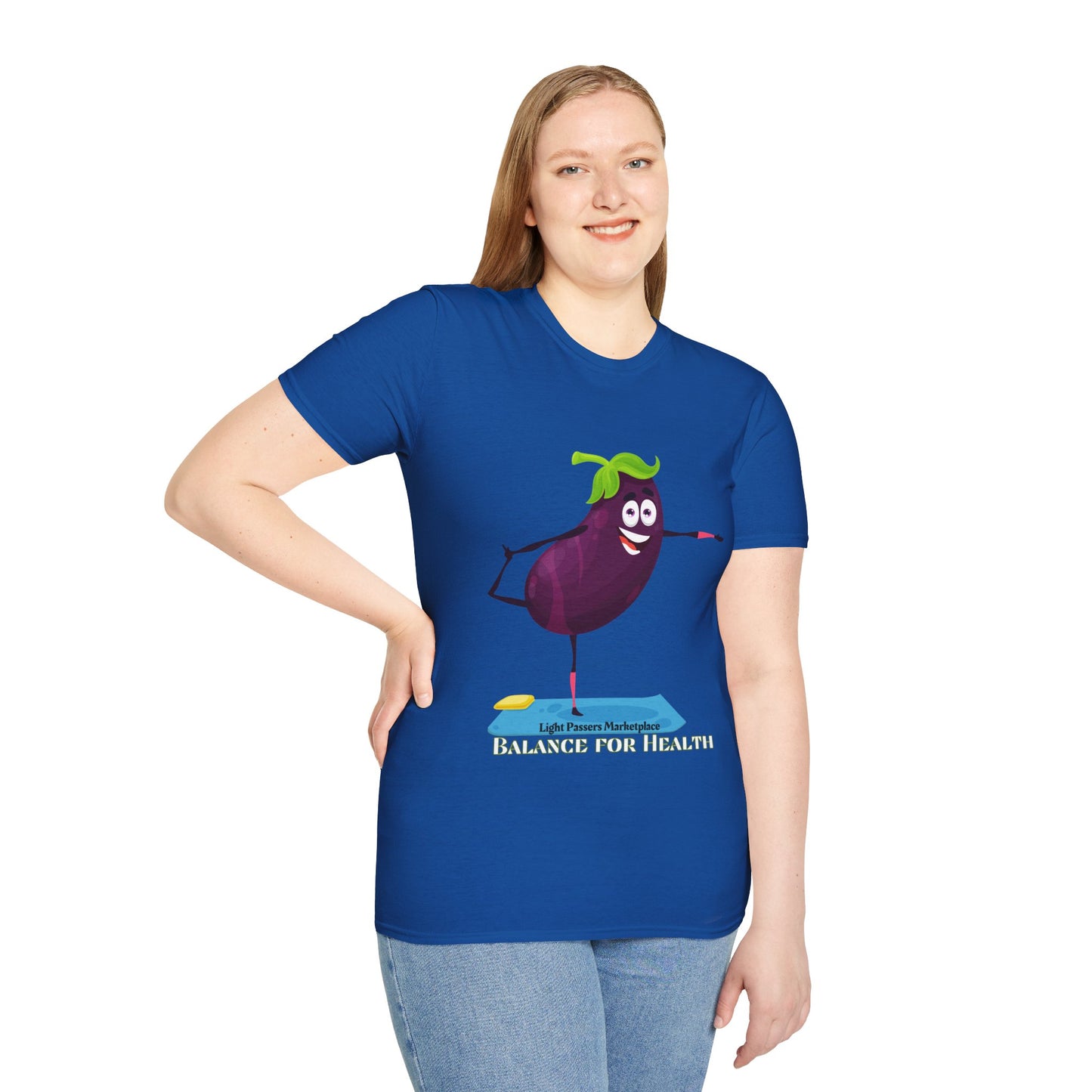 A woman in a blue Eggplant Balance for Health unisex t-shirt, featuring a cartoon eggplant design. Made of soft 100% cotton, with twill tape shoulders for durability and a ribbed collar.