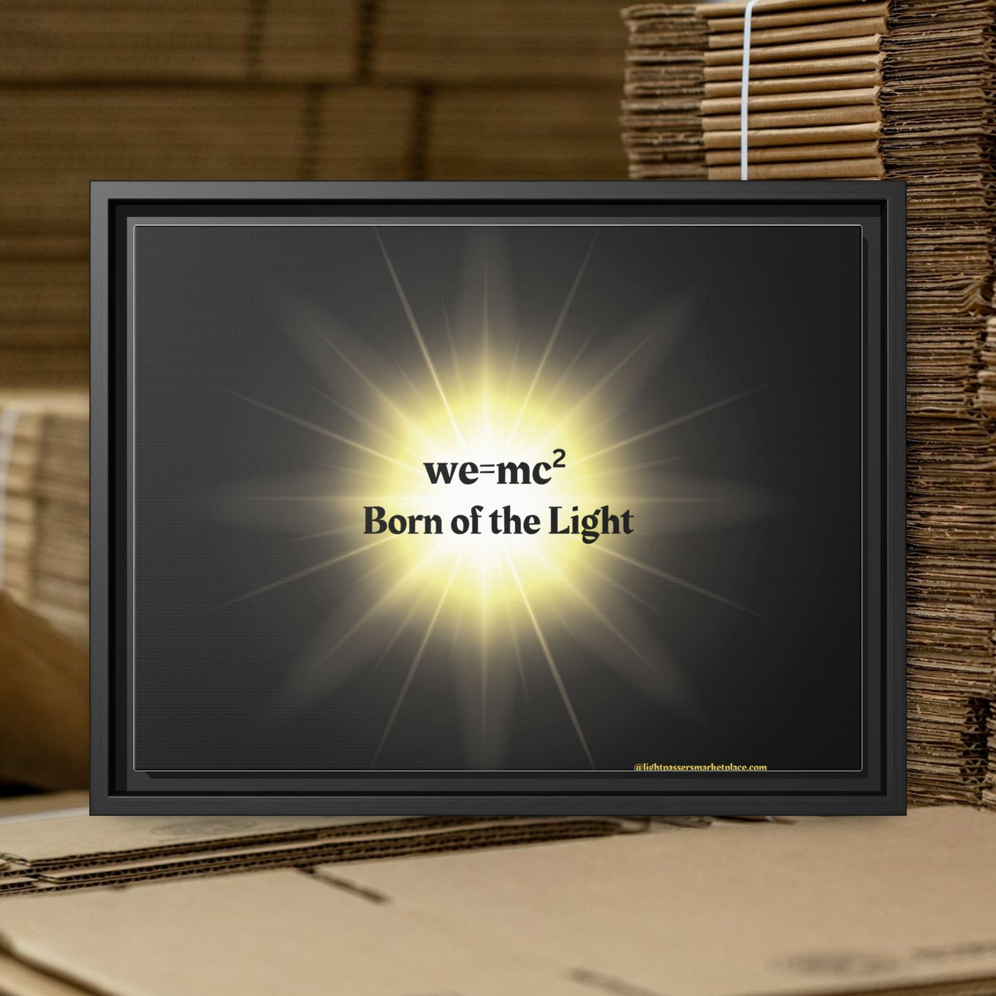 Inspirational Framed Canvas Art - we=mc² Born of the Light, featuring a black frame and glowing artwork, ideal for uplifting any space.