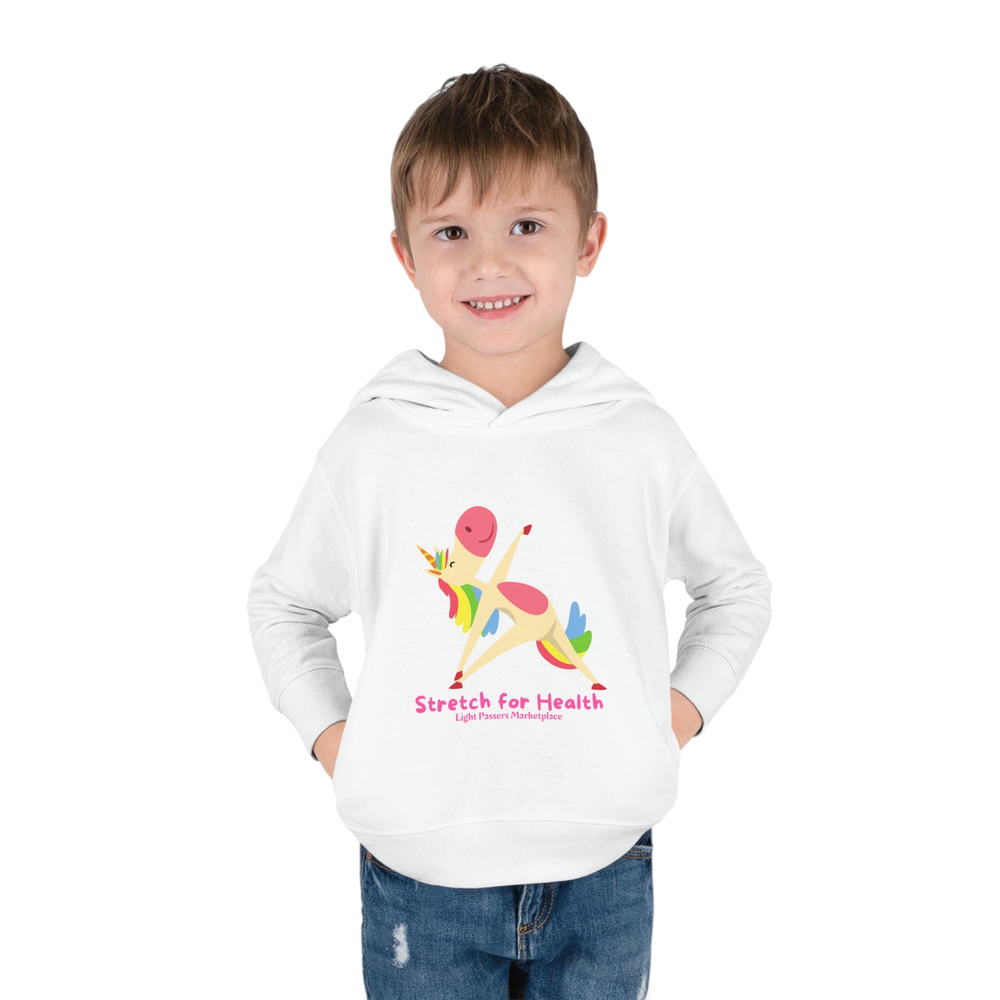 A smiling toddler in a Rabbit Skins Unicorn Stretch Toddler Hooded Sweatshirt with side seam pockets, jersey-lined hood, and cover-stitched details for durability and comfort.