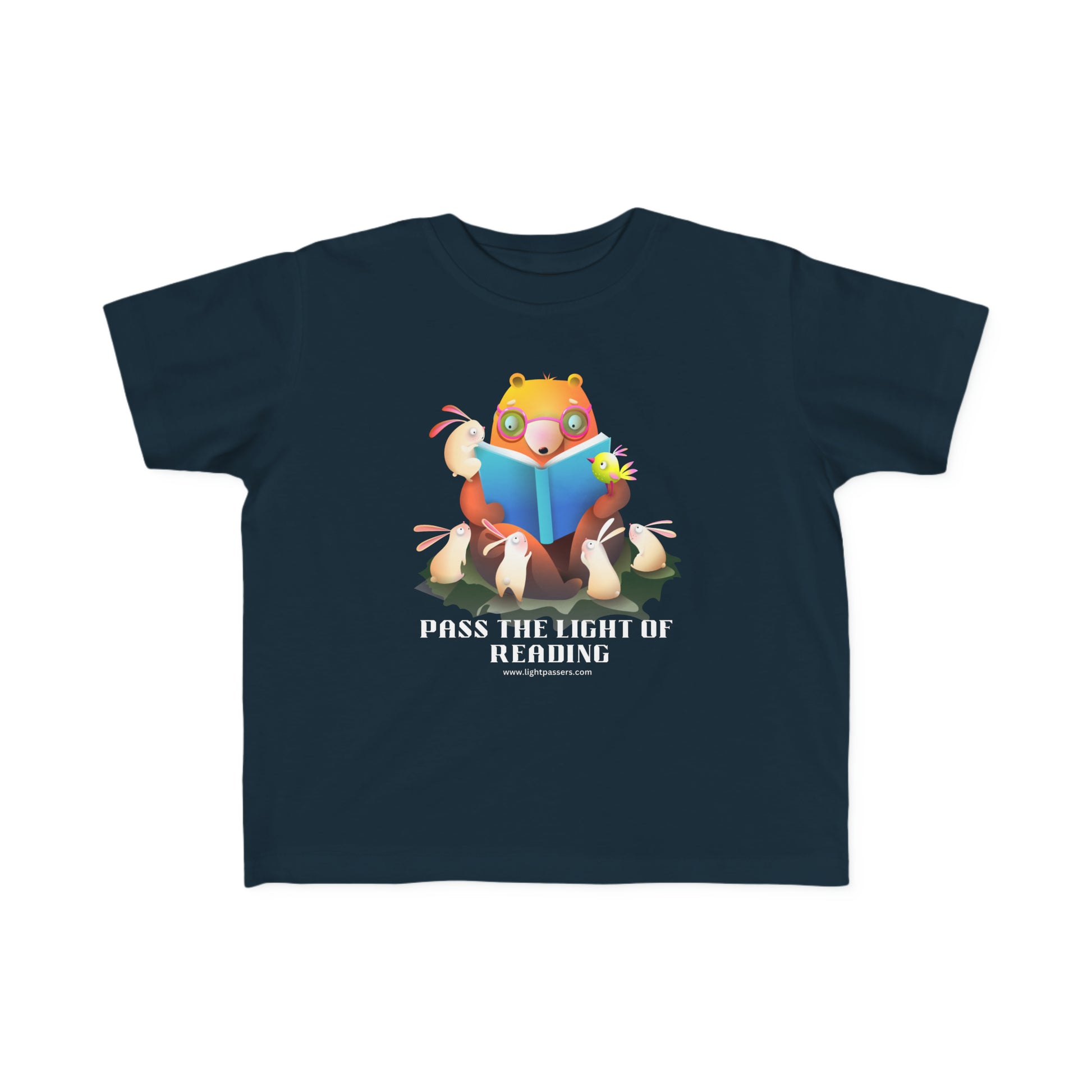 A toddler's tee featuring a cartoon bear reading a book, ideal for sensitive skin. Made of 100% combed cotton, light fabric, tear-away label, and a durable print. Pass the Light of Reading Toddler T-shirt.