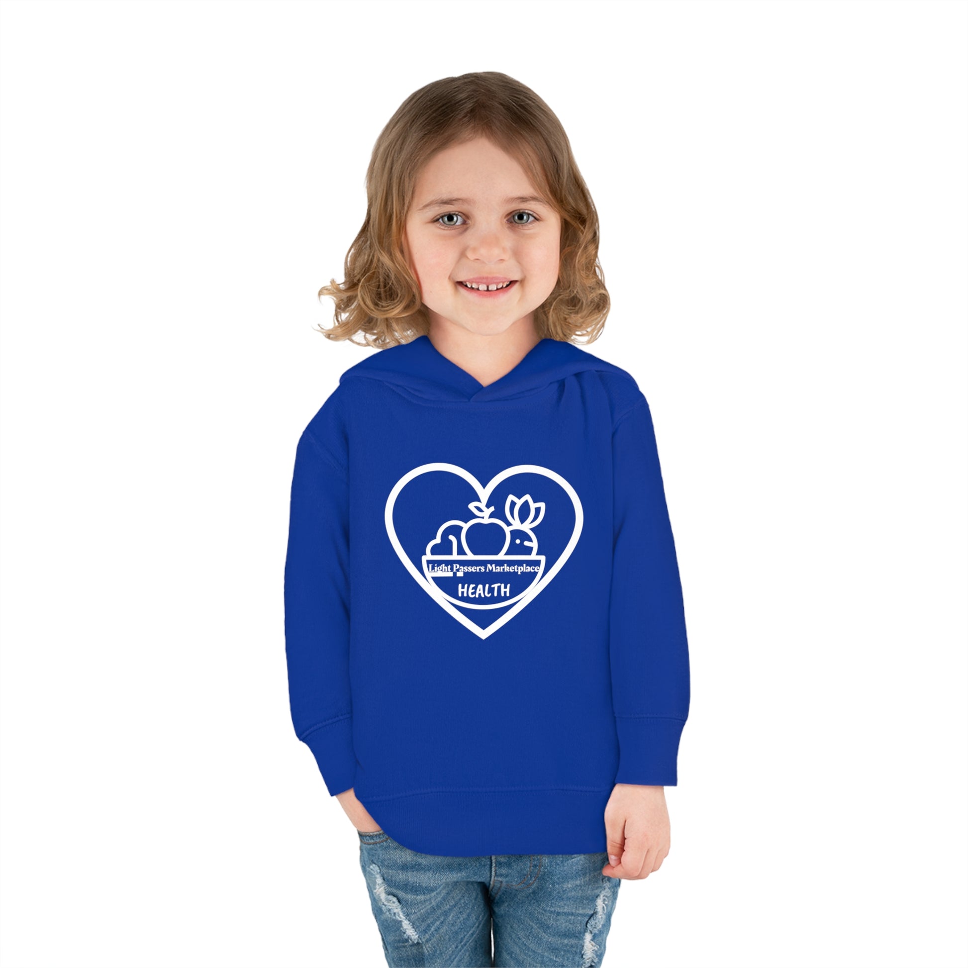 A child in a blue Rabbit Skins toddler hoodie with side seam pockets, smiling at the camera. Features jersey-lined hood, cover-stitched details, and durable cotton-polyester blend for cozy wear.