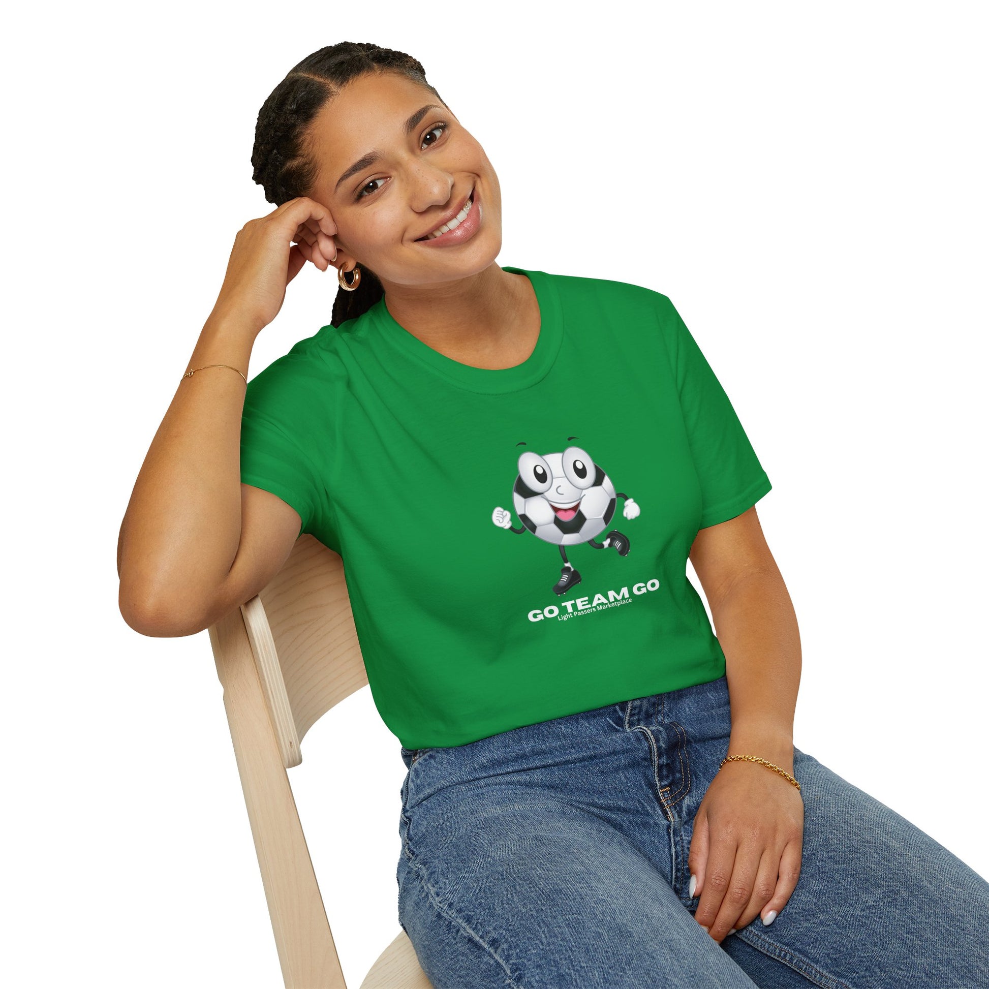 A woman in a green shirt sits on a chair, embodying the casual comfort of the Soccer Ball Guy Team Unisex T-Shirt. Made from soft 100% cotton, featuring twill tape shoulders for durability and a ribbed collar.