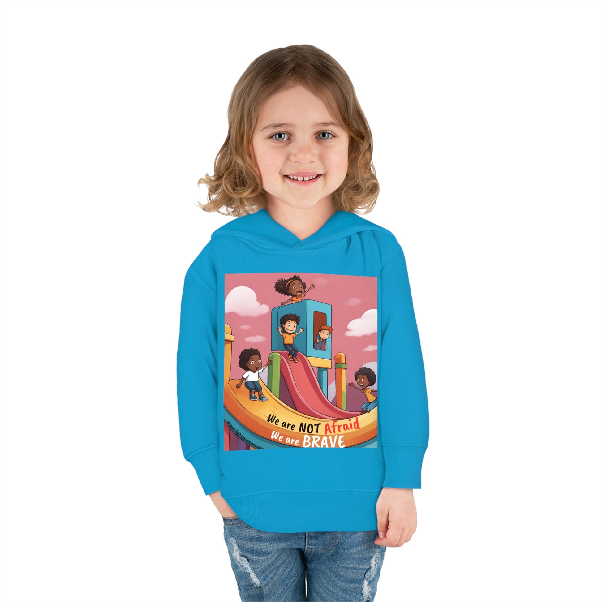 A toddler in a Rabbit Skins hoodie, smiling at the camera. Features jersey-lined hood, cover-stitched details, and side seam pockets for comfort and durability.