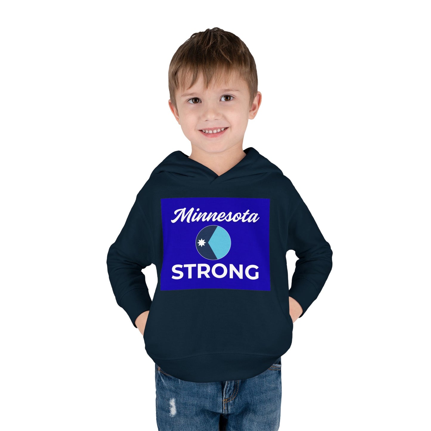 Young boy in a navy Minnesota Strong hoodie, smiling with hands in pockets. The hoodie features a royal blue emblem and script, highlighting Minnesota pride.