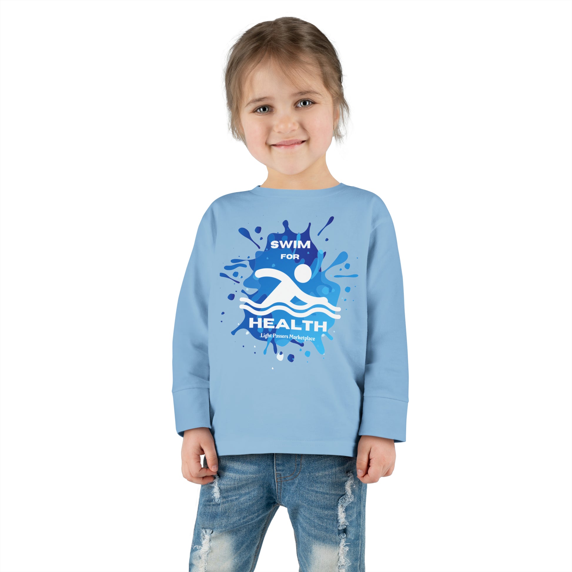 A toddler in a blue long-sleeve tee featuring a Swim for Health logo. Made of 100% combed ringspun cotton with topstitched ribbed collar and tear-away label for comfort and durability.