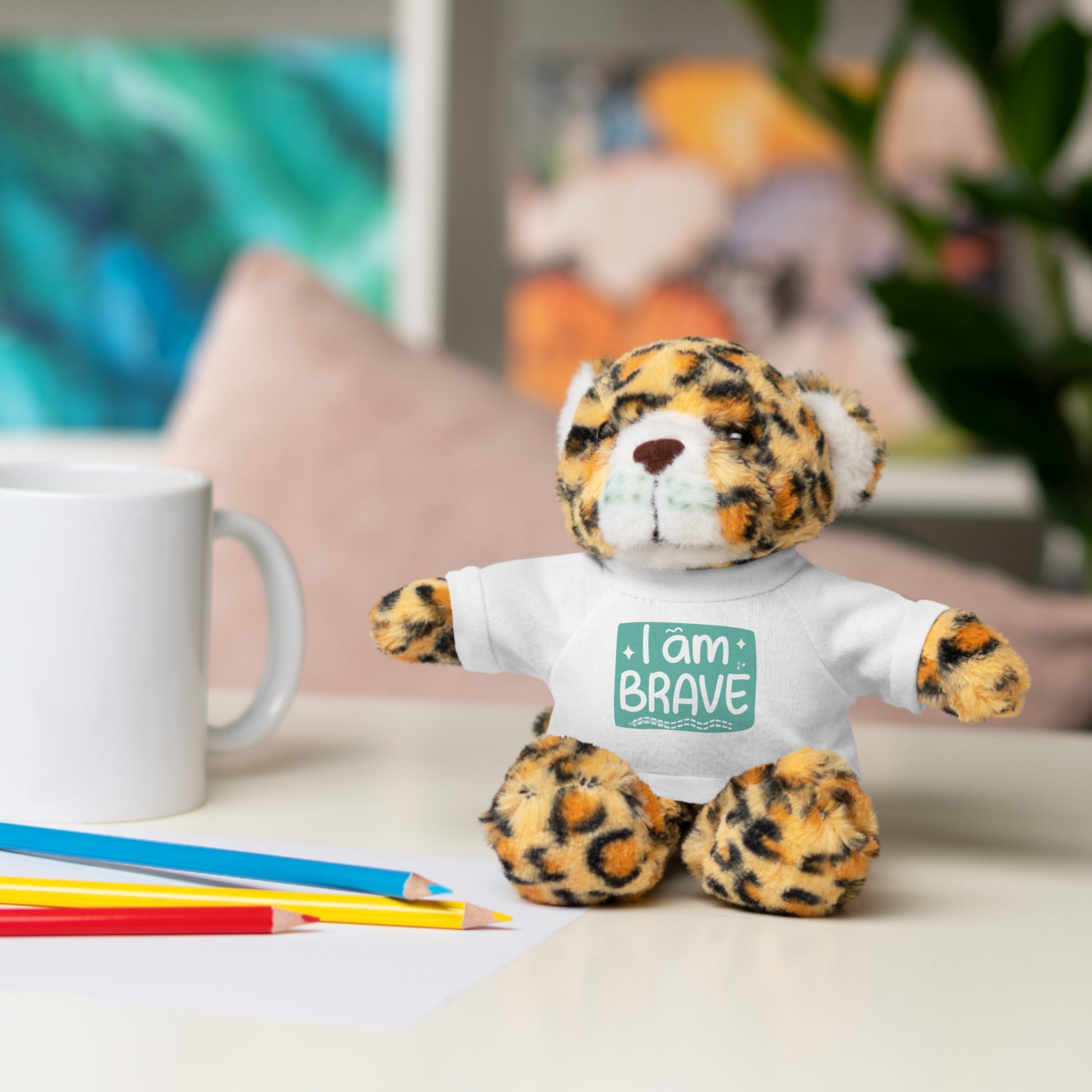 Cool Stuff Stuffies: a stuffed animal with a removable tee featuring I am Brave message, perfect for comfort and decor, shown on a table.