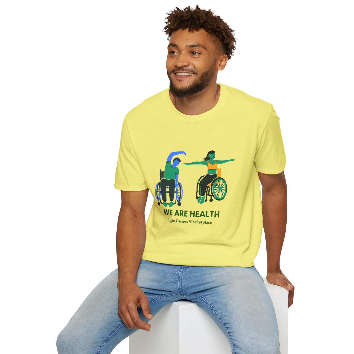 A man in a wheelchair and a woman on a cube, showcasing the Wheelchair Yoga Unisex T-Shirt. Made of soft, durable 100% cotton with twill tape shoulders and no side seams for ultimate comfort.