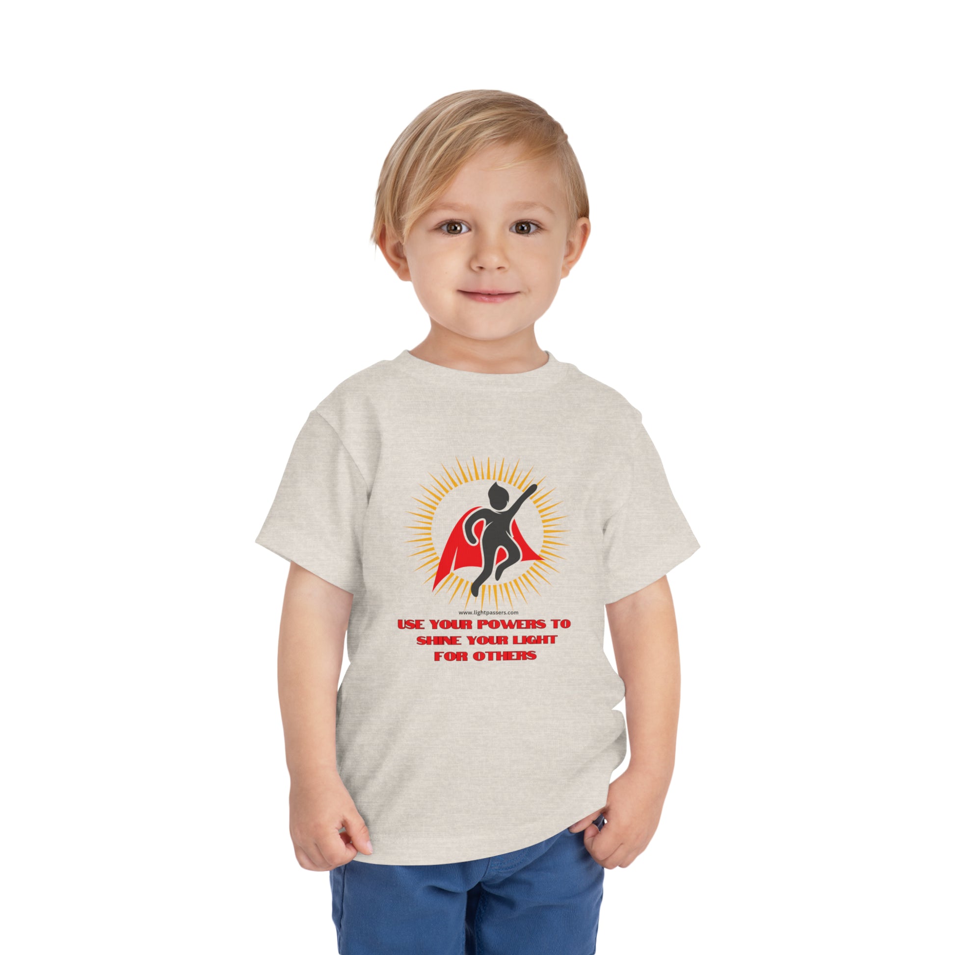 A toddler in a white shirt with a cape, close-up of face, and pants. Bella Canvas tee, 100% Airlume cotton, tear-away label. Use Your Powers Toddler T-shirt.