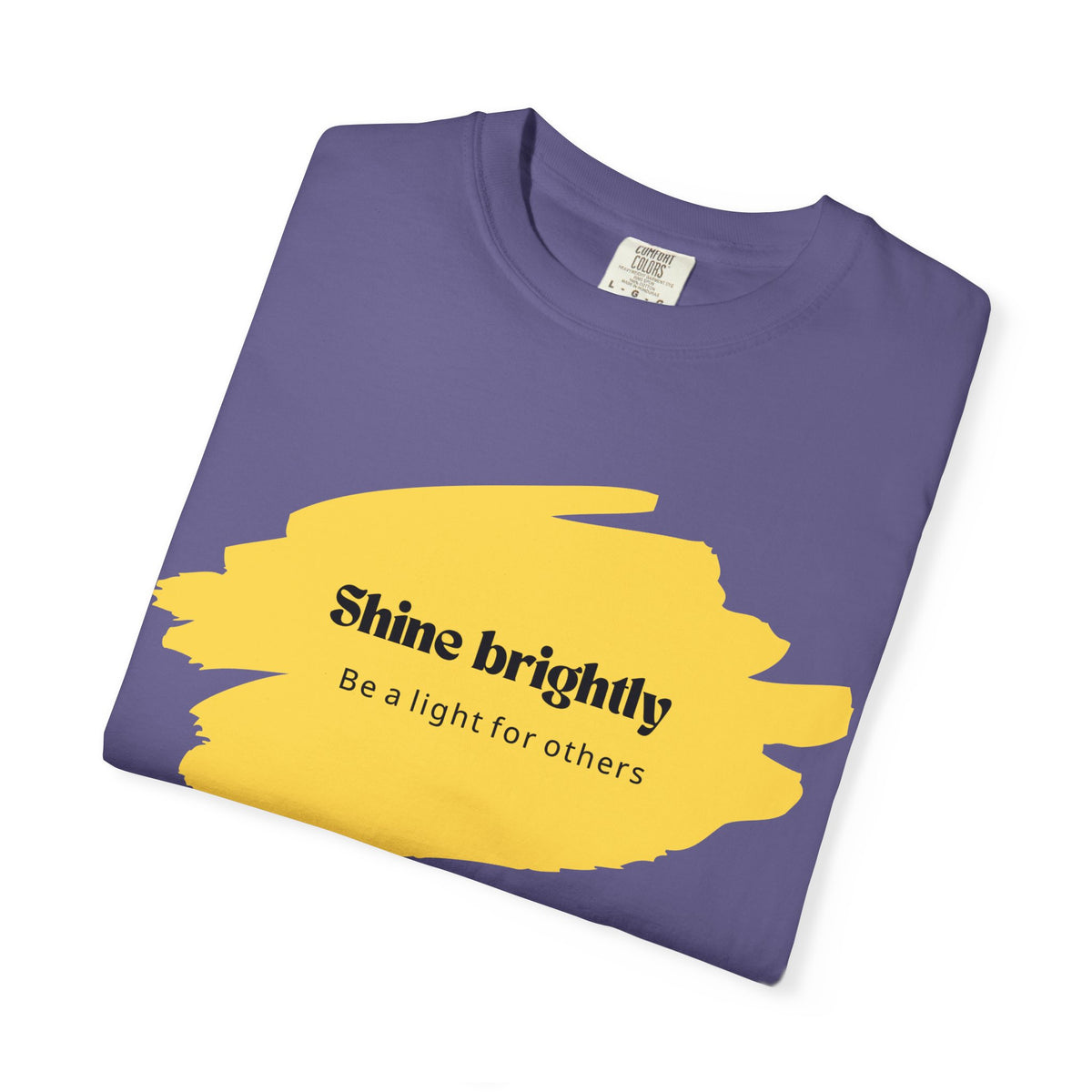 Unisex T-shirt in grape purple with yellow “Shine brightly” graphic on chest
