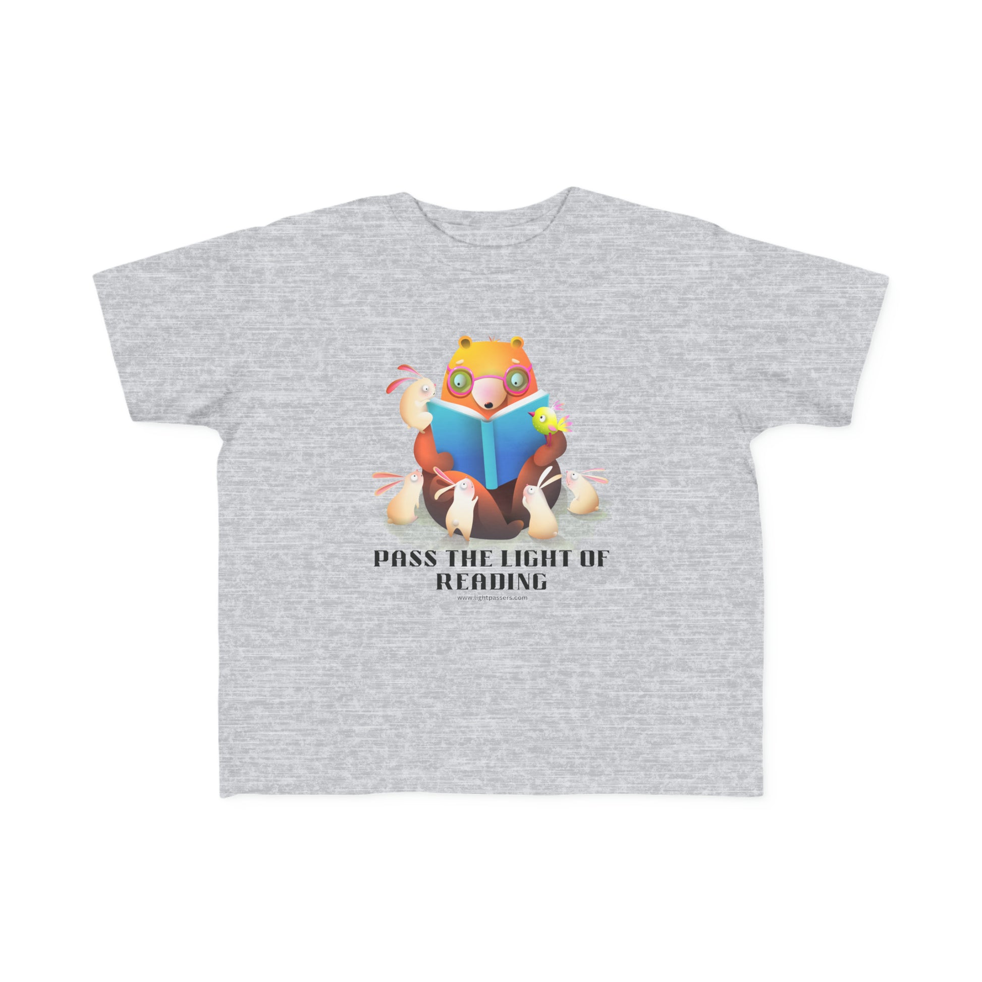 A toddler's tee featuring a cartoon bear reading a book, ideal for sensitive skin. Made of 100% combed cotton, light fabric, tear-away label, and a classic fit.