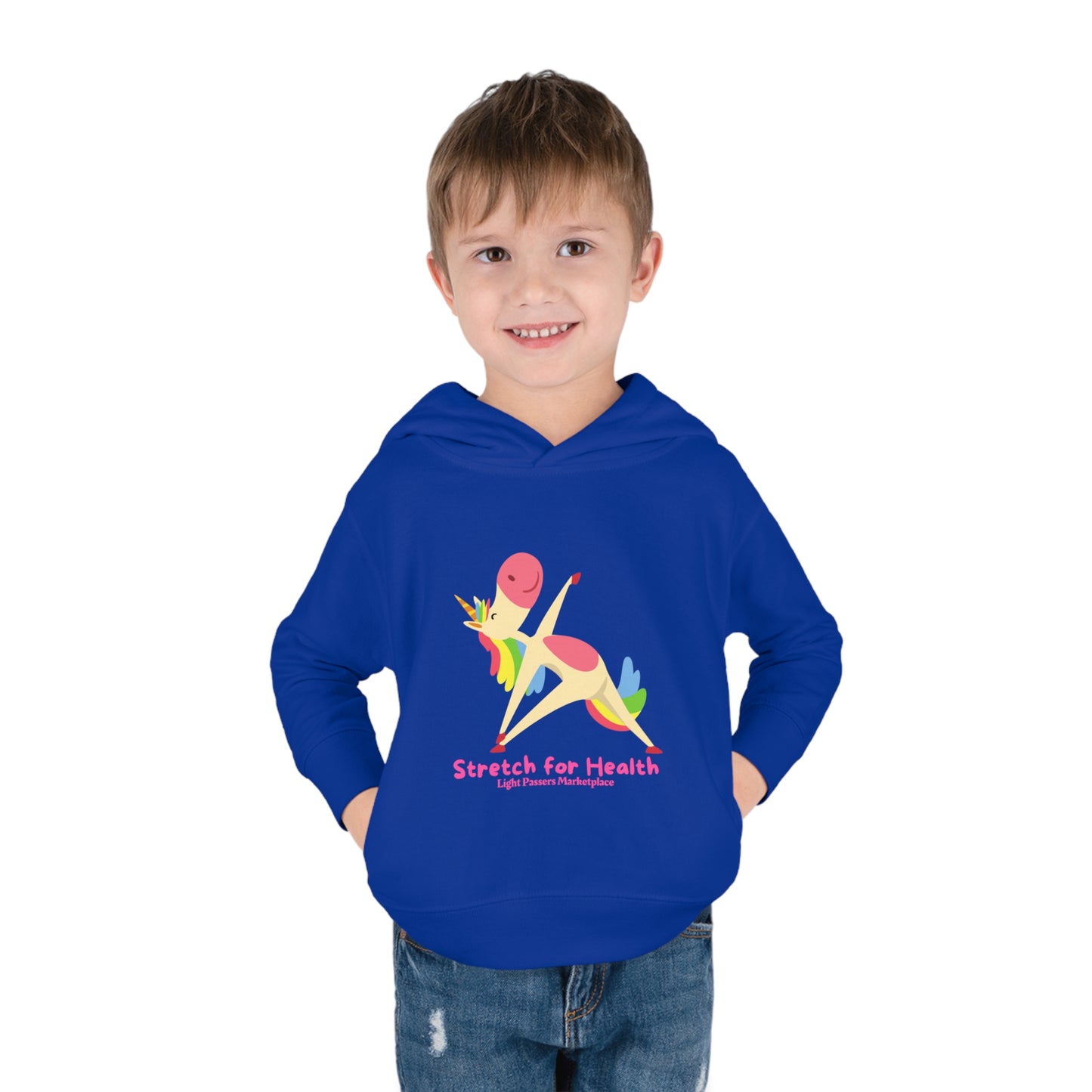 A smiling boy in a Unicorn Stretch Toddler Hoodie with jersey-lined hood, cover-stitched details, and side seam pockets for cozy durability.