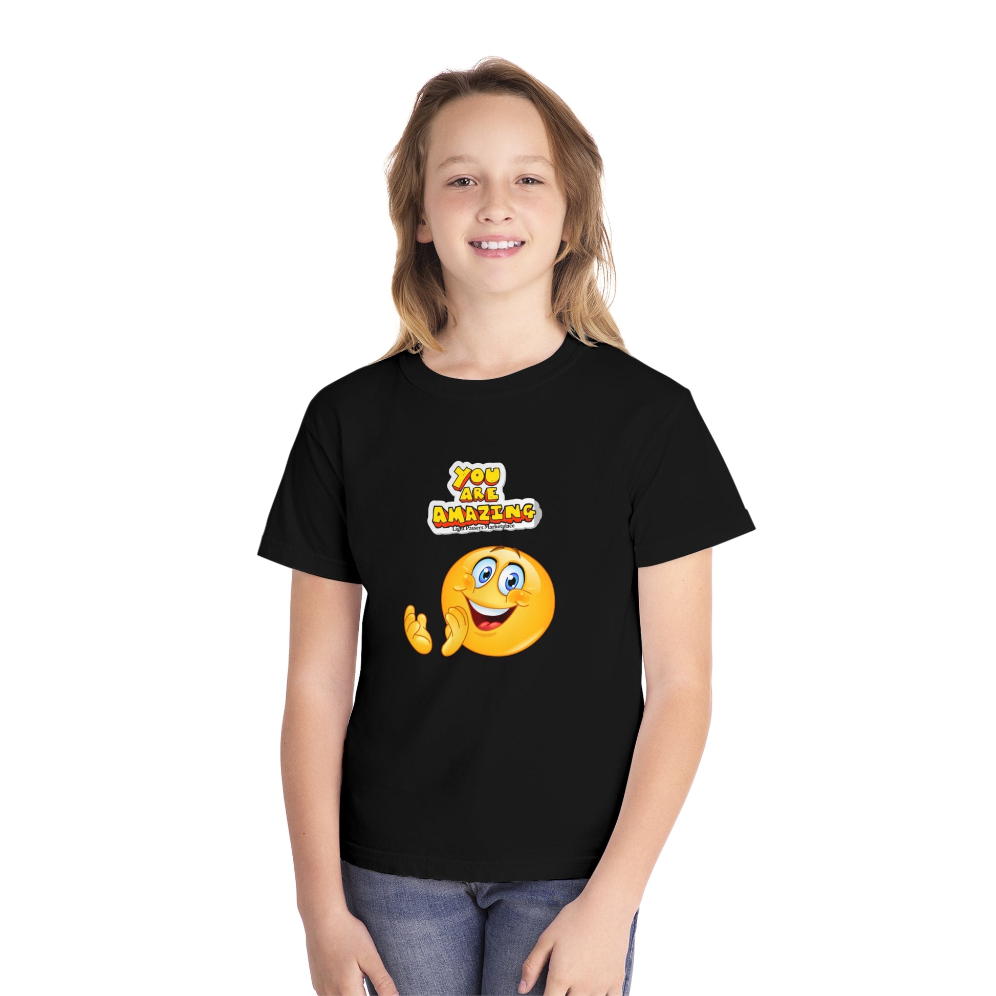 A girl in a black shirt smiling, showcasing the You are Amazing Clap Youth T-shirt. Made of 100% combed ringspun cotton for comfort and agility. Classic fit, perfect for active kids.