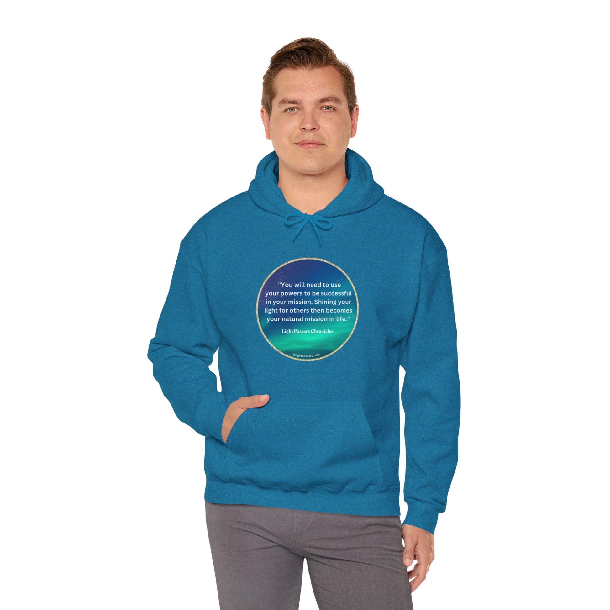 A person in a blue sweatshirt with a circular design, featuring a kangaroo pocket and matching drawstring hood. Made of 50% cotton and 50% polyester for warmth and comfort.