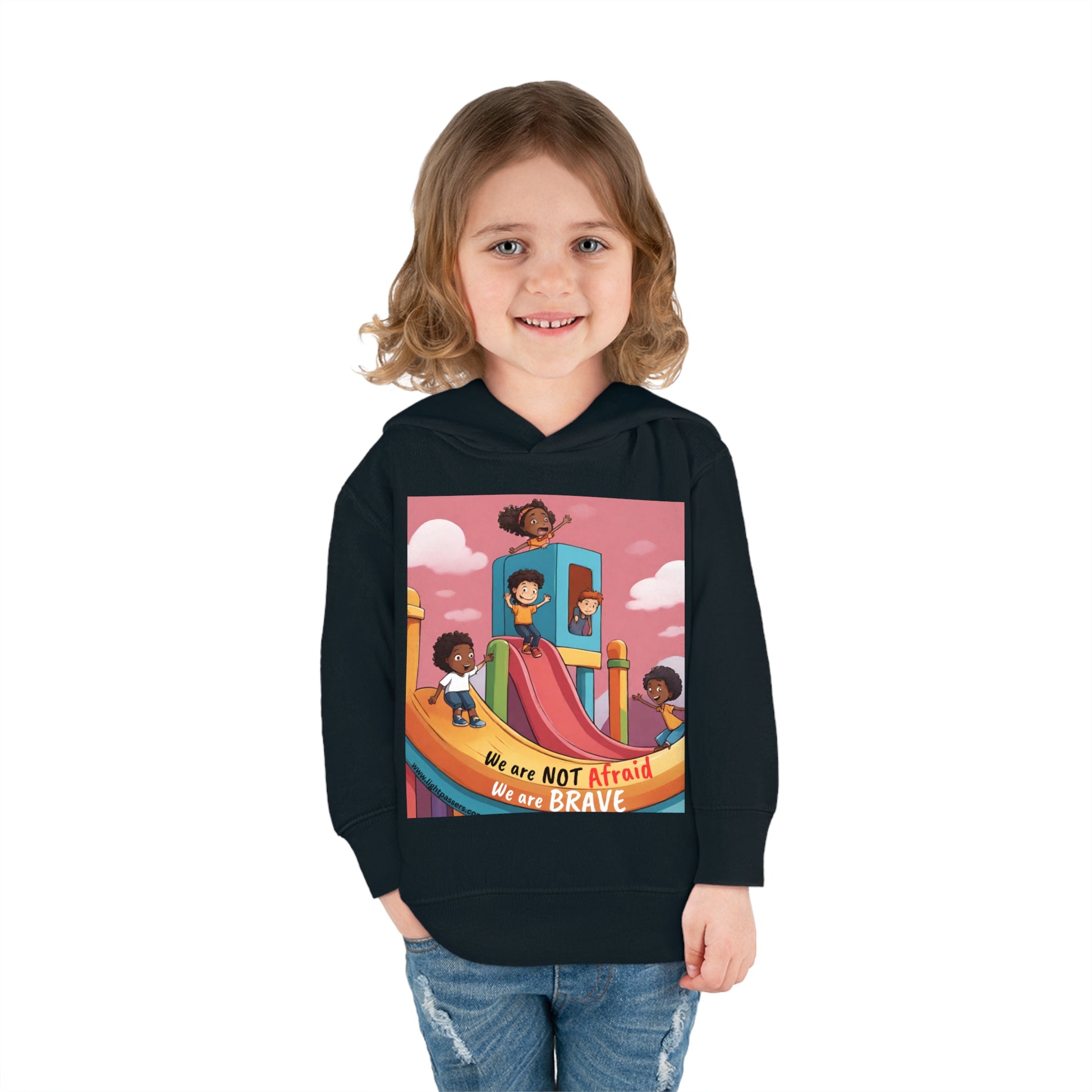 A smiling child in a Rabbit Skins toddler hoodie with jersey-lined hood, cover-stitched details, and side seam pockets for cozy durability.