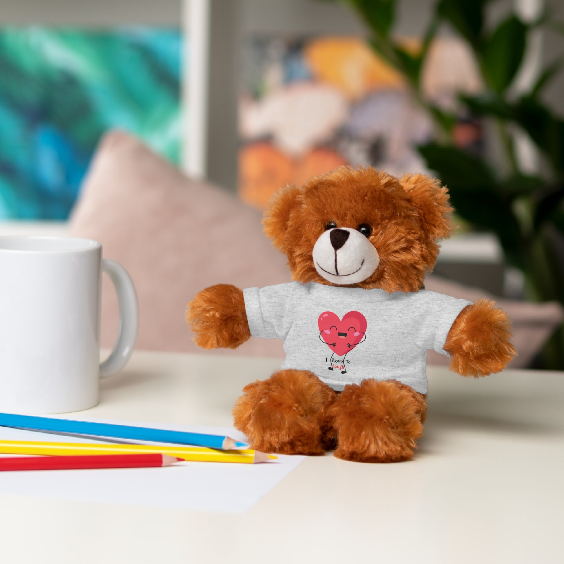 Teddy bear wearing a removable I Love to Laugh heart shirt, part of Cool Stuff Stuffies' collection of six customizable stuffed animals.