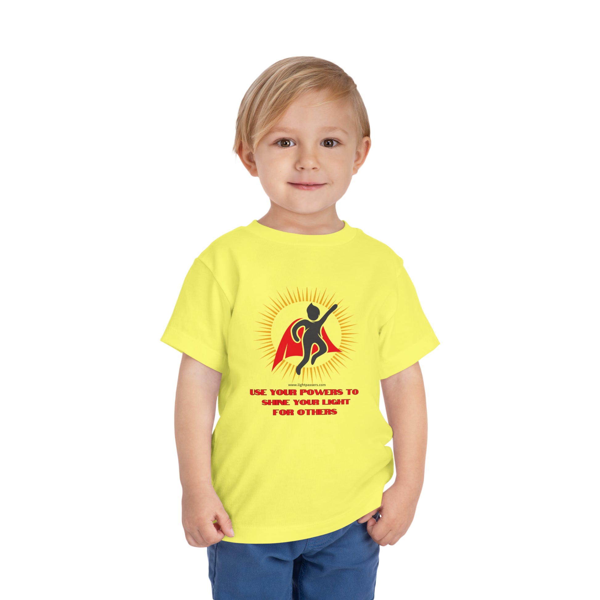 A toddler in a yellow Use Your Powers t-shirt, showcasing Bella Canvas cotton jersey fabric with a tear-away label for comfort.