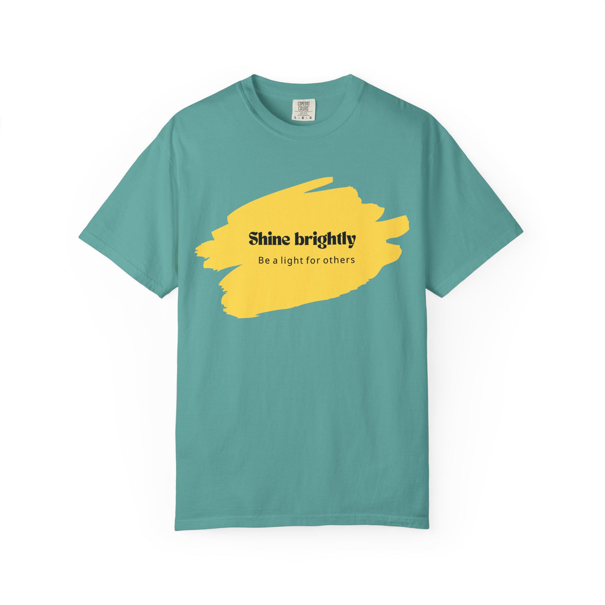 Seafoam unisex T-shirt with yellow paint-splash graphic and “Shine brightly” text