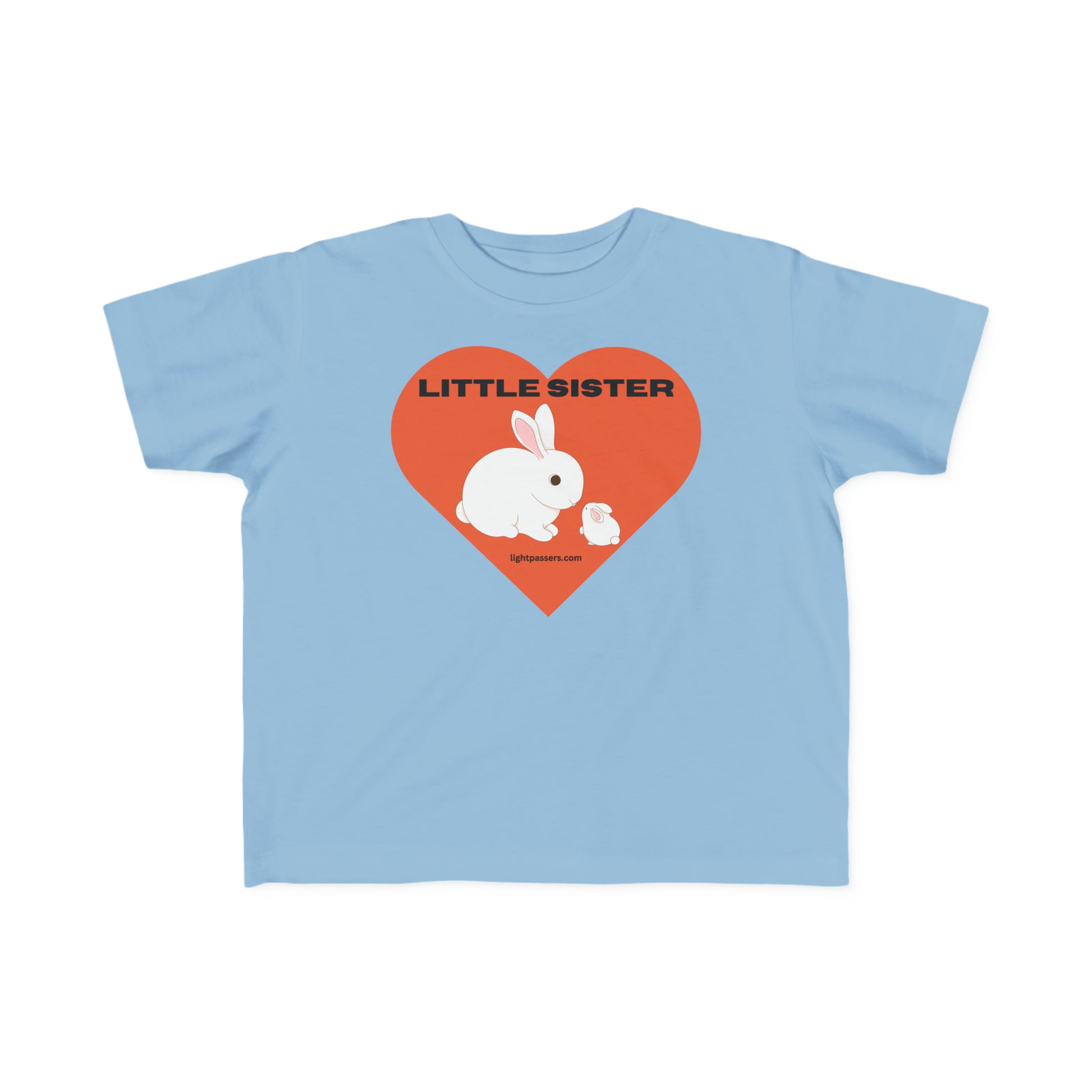 A Little Sister Toddler T-shirt featuring a soft, durable blue fabric with a white rabbit and heart print, ideal for sensitive skin. Made of 100% combed cotton, light and tear-away label included.