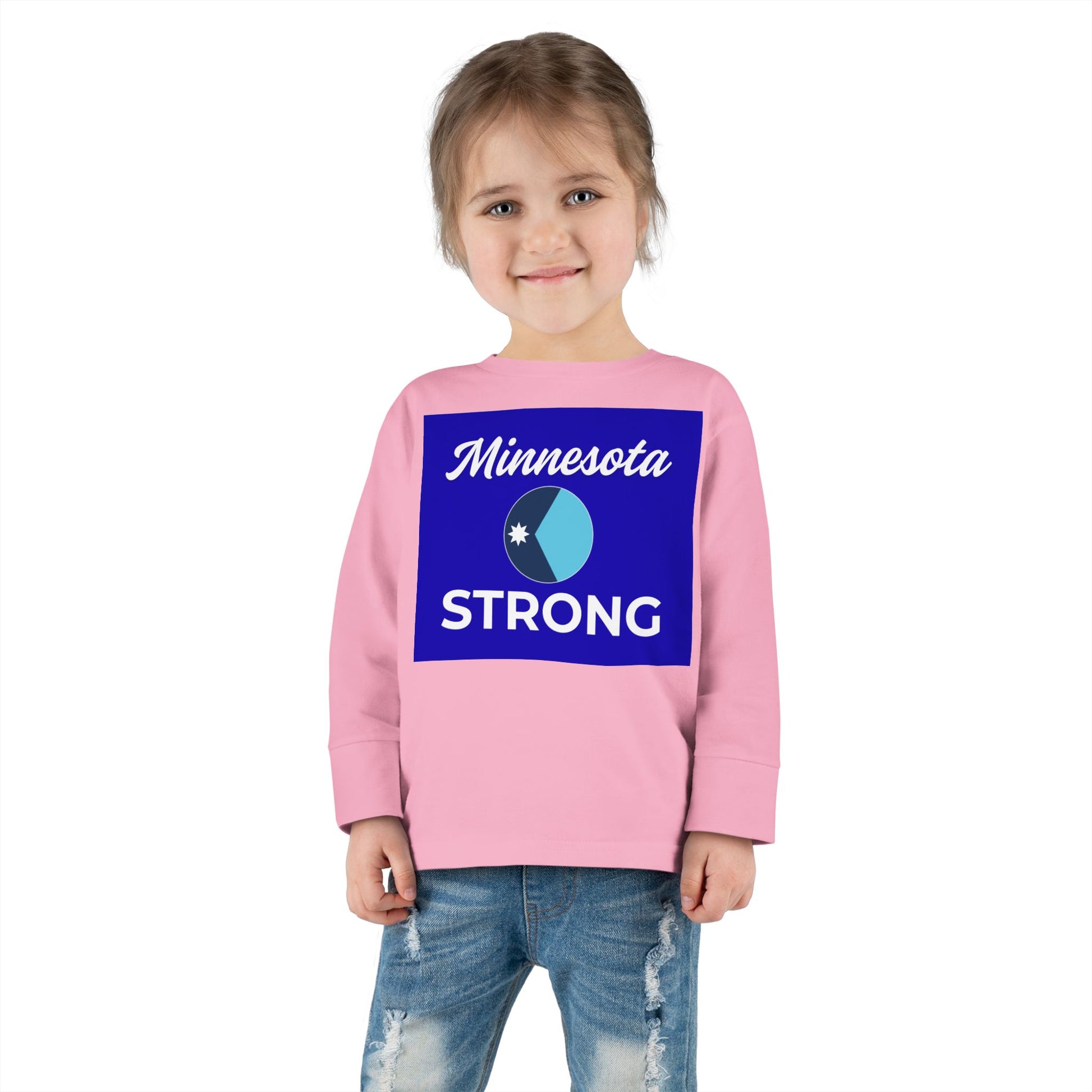 Young girl in a Minnesota Strong long-sleeve tee from Light Passers Marketplace, showcasing community pride with a royal-blue graphic and comfortable fit.