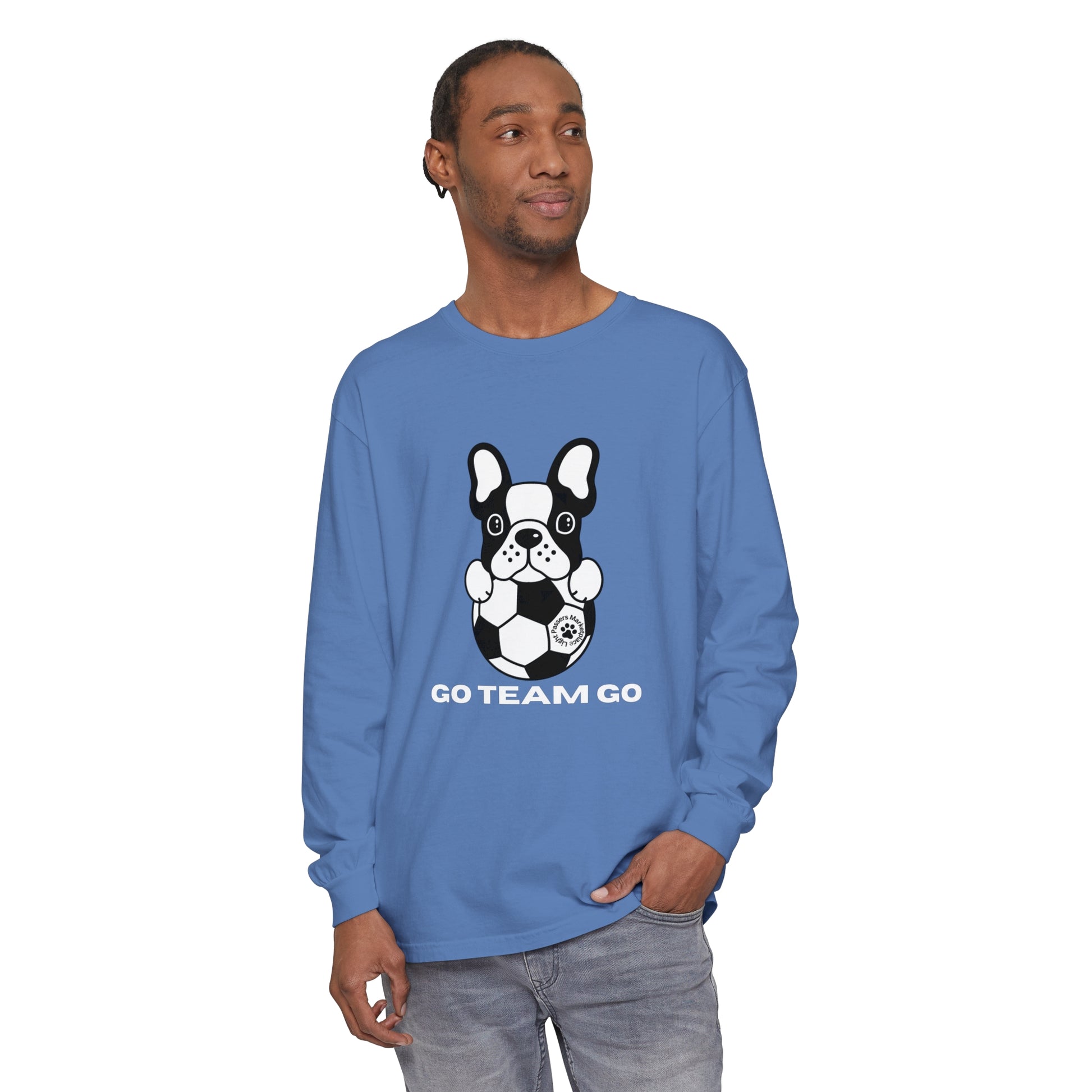 Person wearing a Teams Soccer Dog Adult Unisex Garment-dyed Long Sleeve, featuring a dog with a football. Relaxed fit, made of 100% ring-spun cotton.