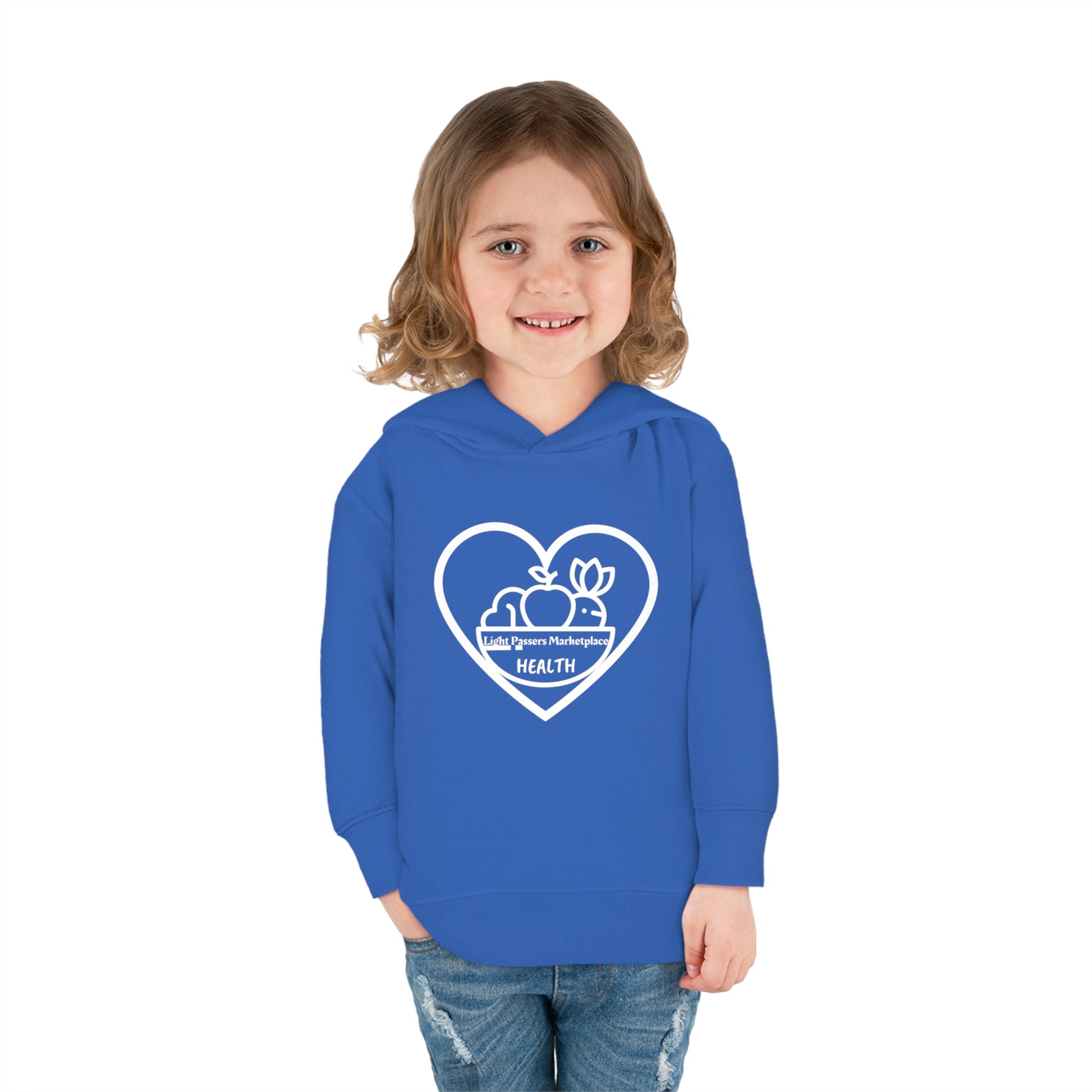 A child in a blue Fruit Basket Toddler Hoodie, smiling at the camera. Features jersey-lined hood, cover-stitched details, and side seam pockets for cozy comfort.