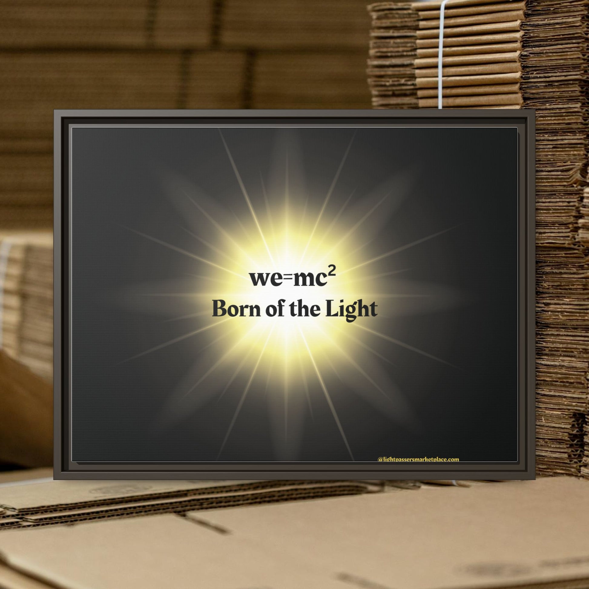 Inspirational Framed Canvas Art - we=mc² Born of the Light, showcasing a matte canvas with a black frame, illuminated to highlight its motivational message.