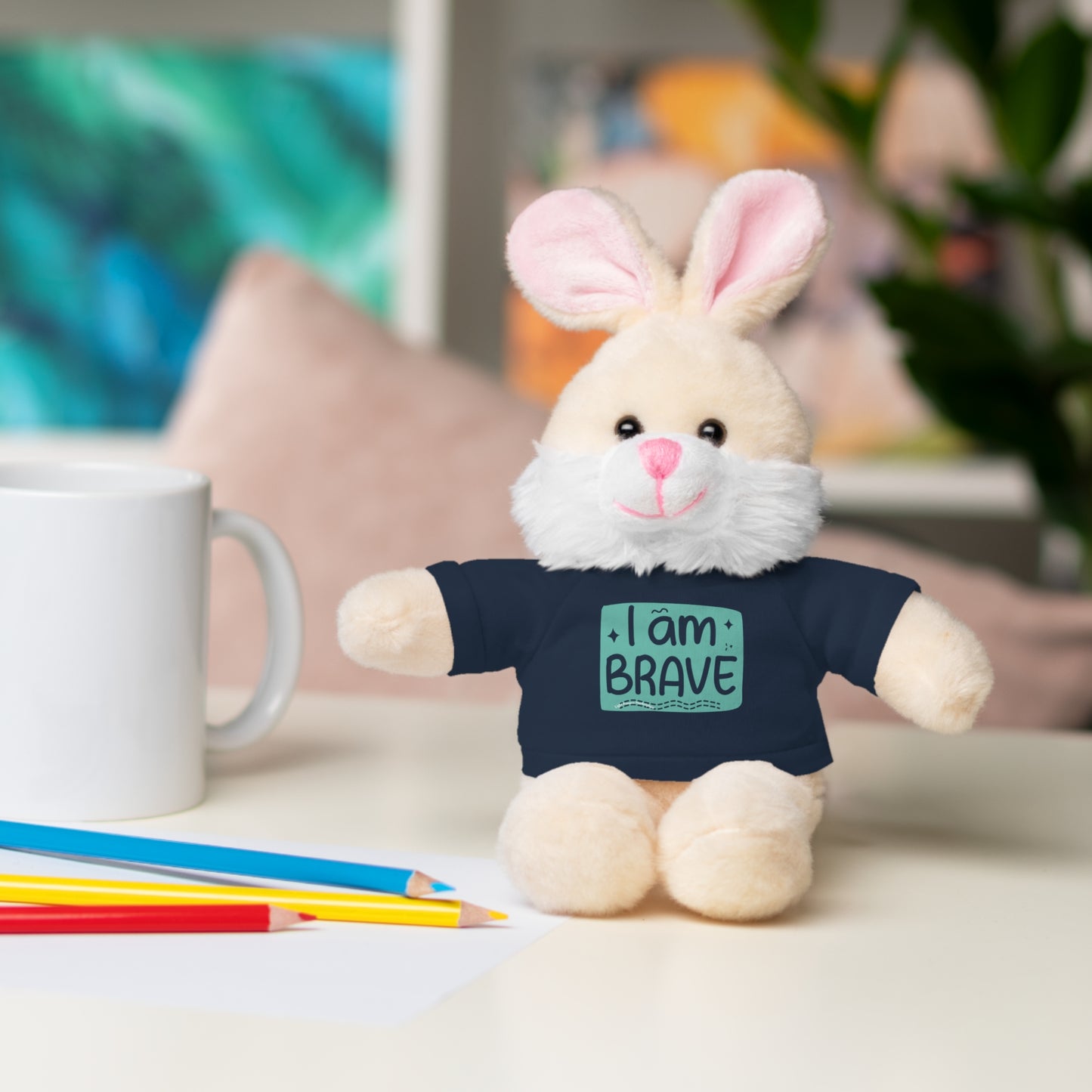 Cool Stuff Stuffies Bunny stuffed animal with removable I am Brave tee, sitting on a table. Perfect for comfort and decor.