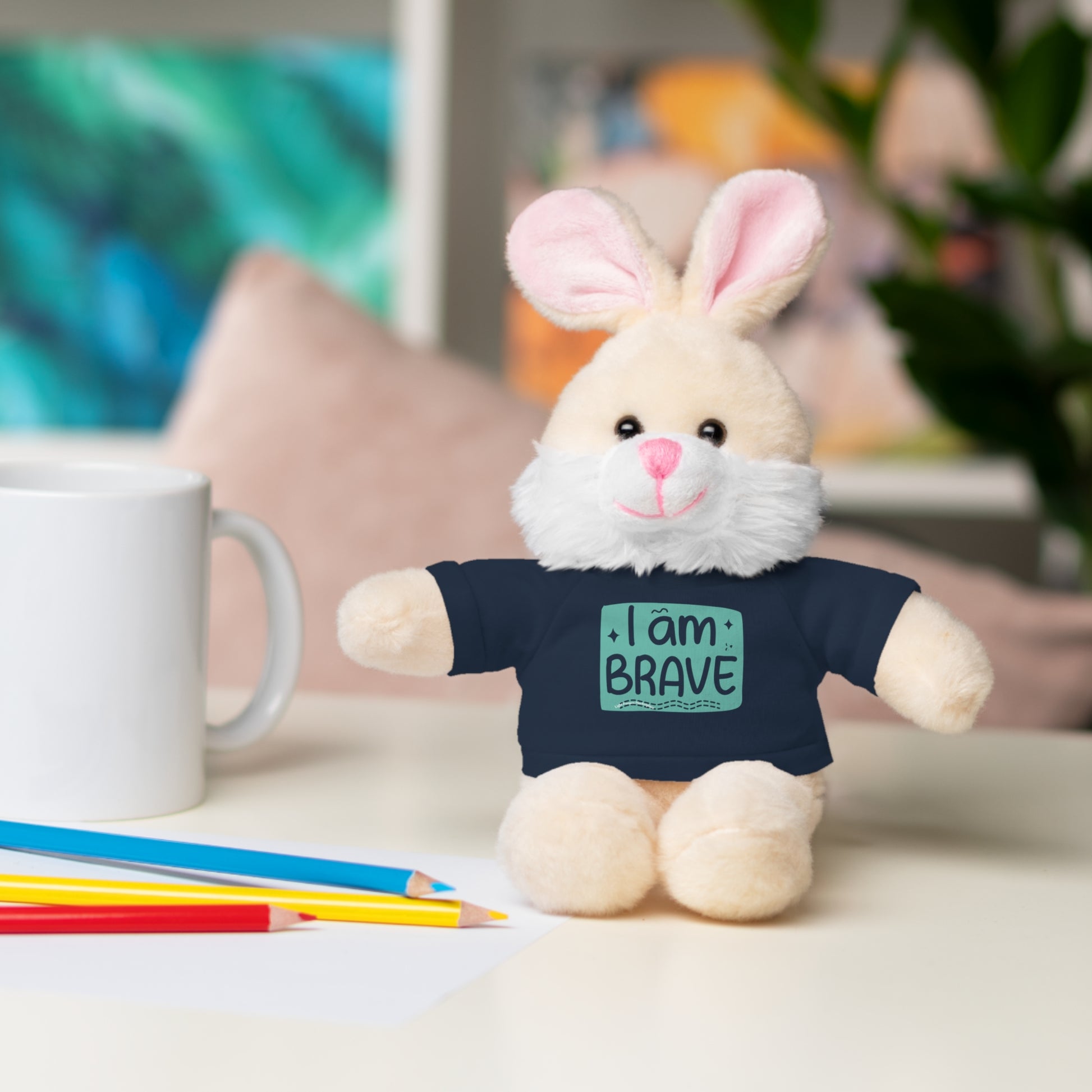 Cool Stuff Stuffies Bunny stuffed animal with removable I am Brave tee, sitting on a table. Perfect for comfort and decor.