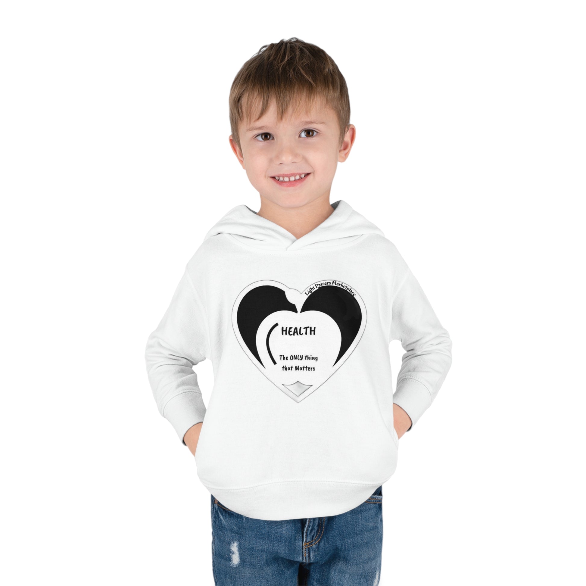 A smiling boy in a Rabbit Skins toddler hoodie with hands in pockets. Jersey-lined hood, cover-stitched details, side seam pockets for cozy comfort. Made of 60% cotton, 40% polyester blend.