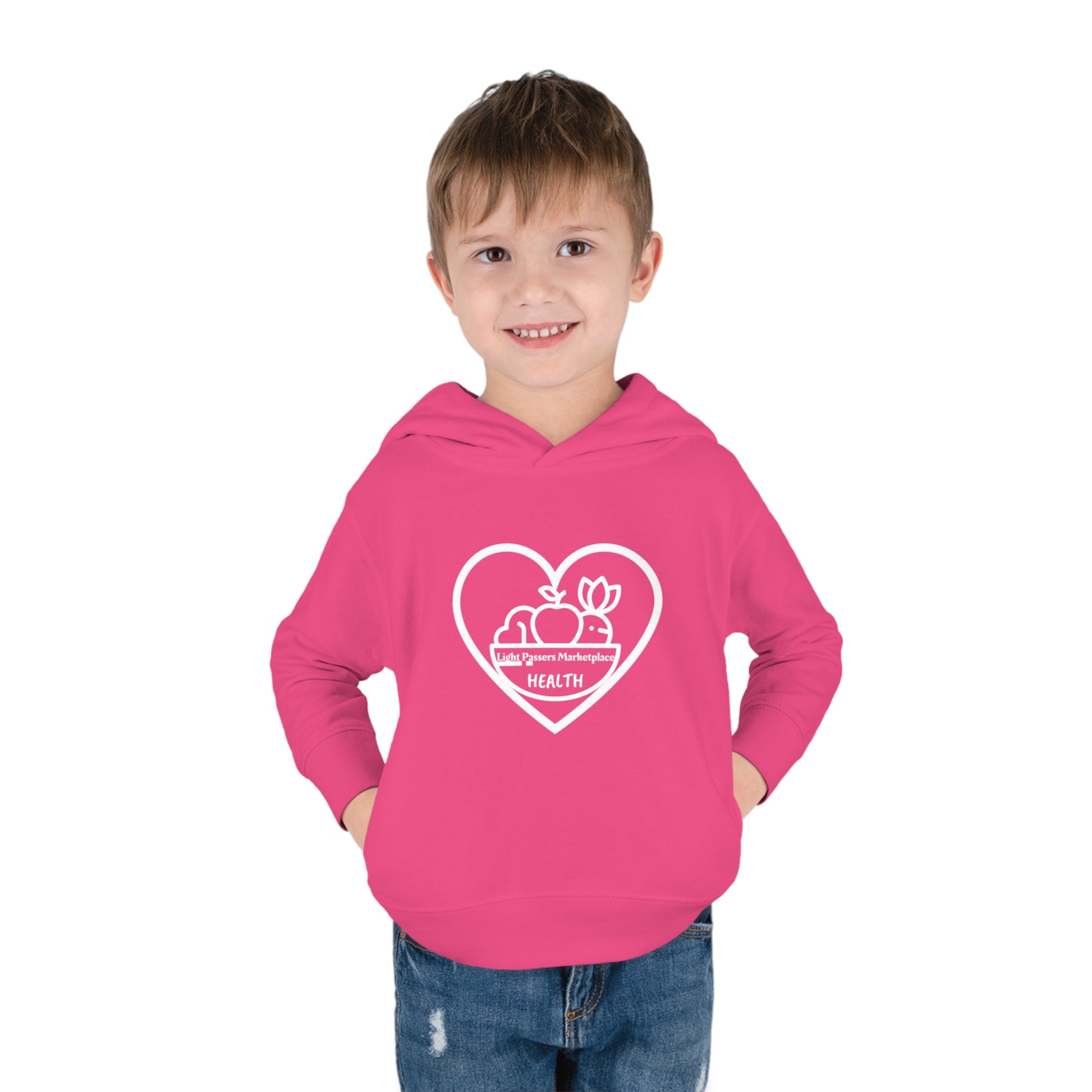 A toddler in a pink hoodie with hands in pockets, showcasing a close-up of the hood and side-seam pockets. Designed for comfort with double-needle stitching and a jersey-lined hood.