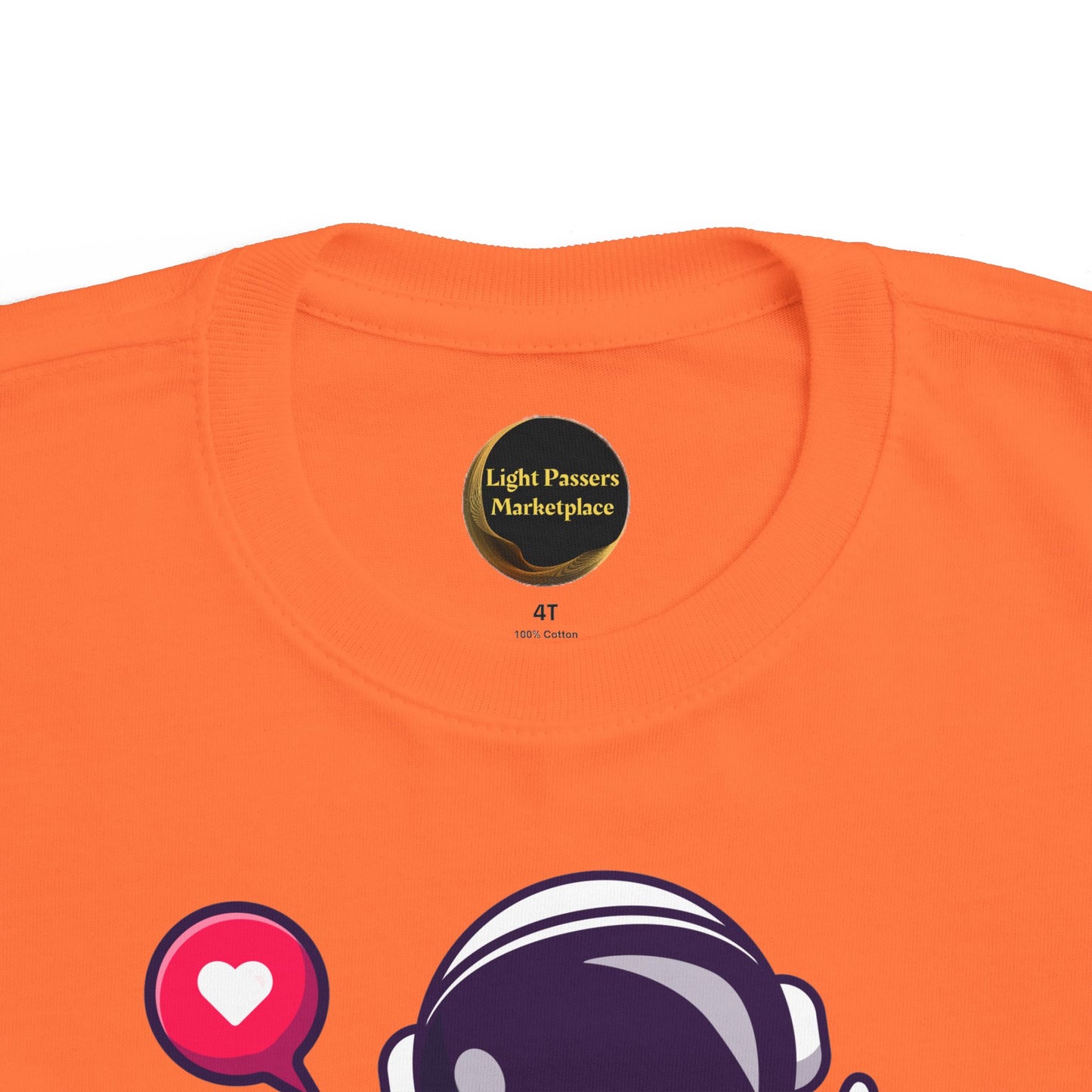 Peace Astronaut Toddler T-shirt featuring a bright orange design with a partial astronaut helmet graphic and a Light Passers Marketplace label inside the collar.