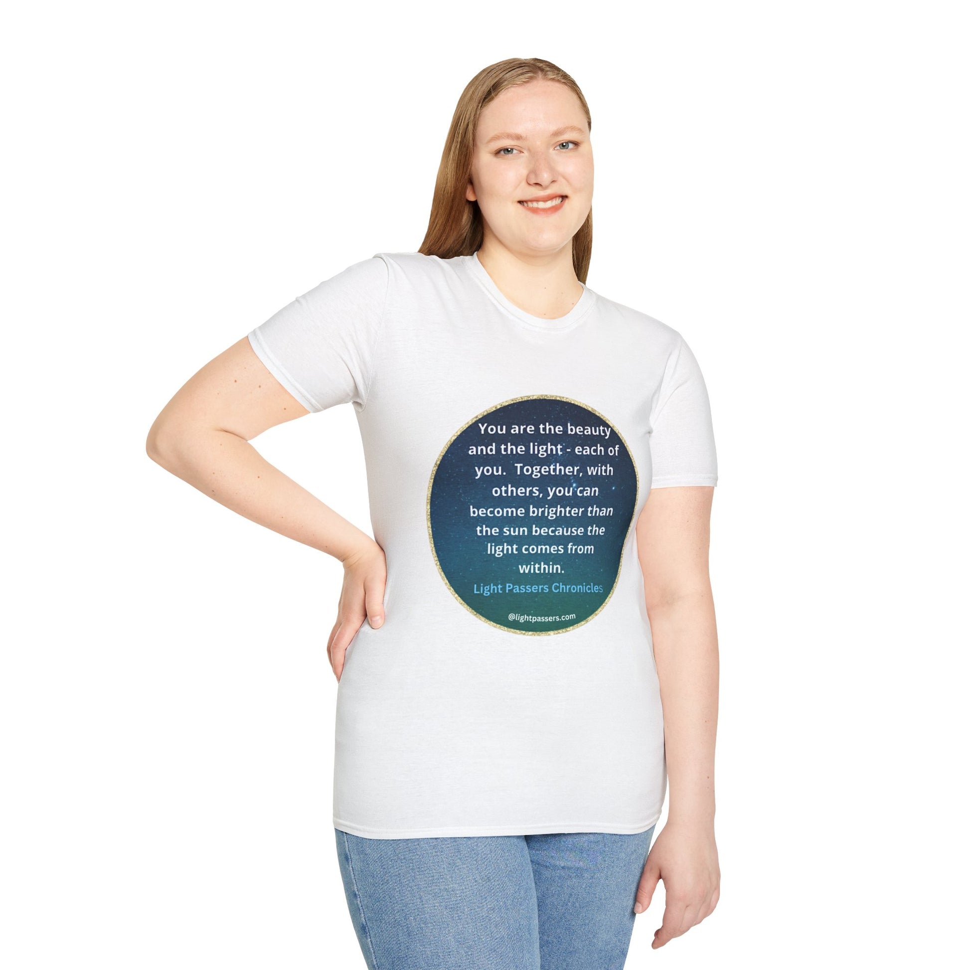 A woman in a white shirt with a blue circle and white text smiles, showcasing the Beauty and the Light Unisex T-shirt. The close-up highlights the smooth fabric and durable design.