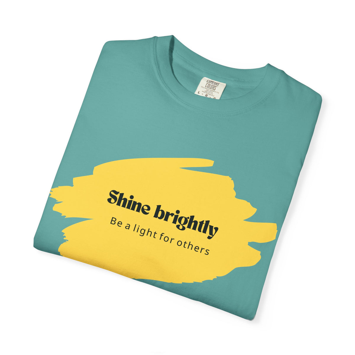 Seafoam unisex T-shirt with yellow “Shine brightly” graphic and crew neck.