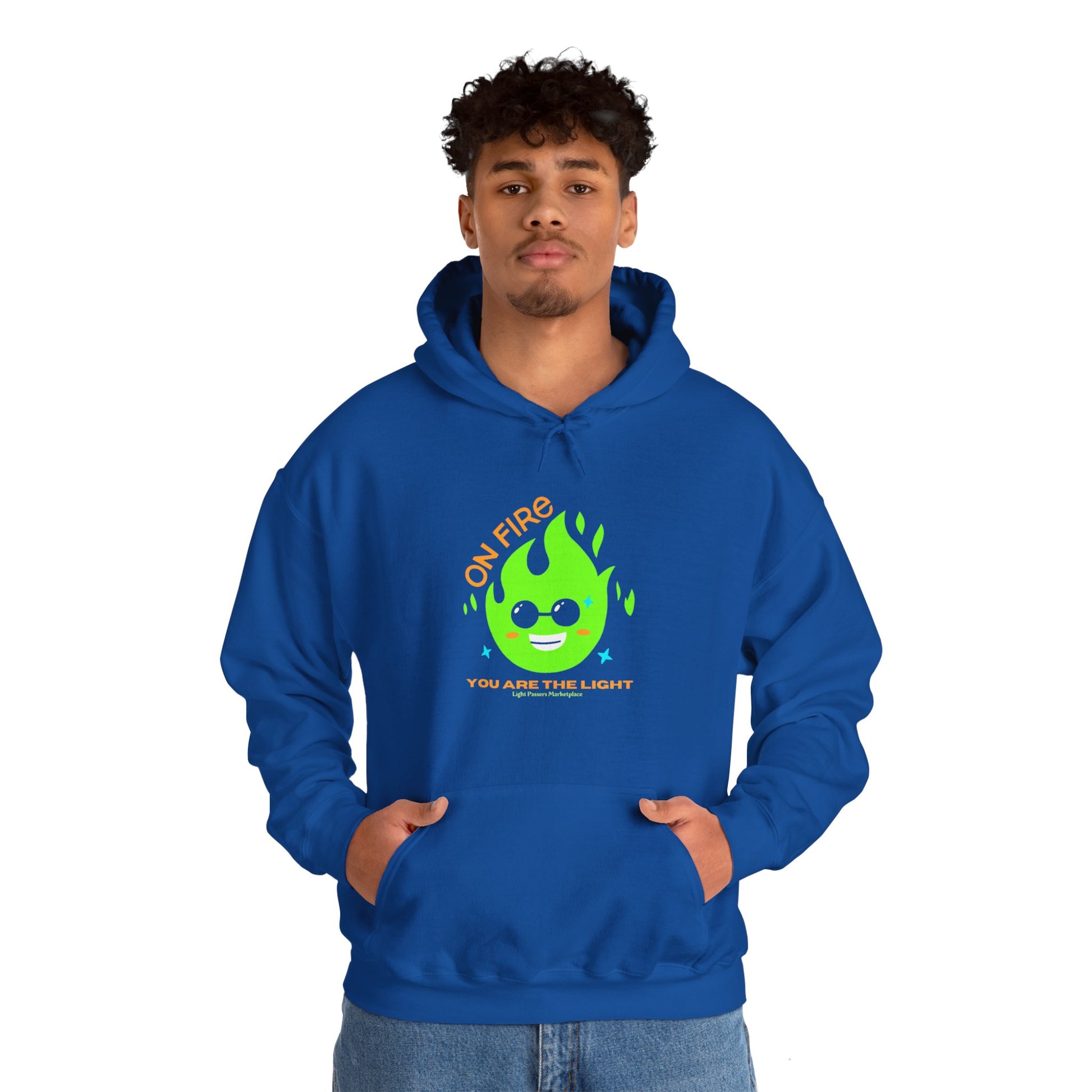 A man in a blue hooded sweatshirt with a cartoon fire design, featuring a kangaroo pocket and color-matched drawstring. Made of 50% cotton and 50% polyester for warmth and comfort.