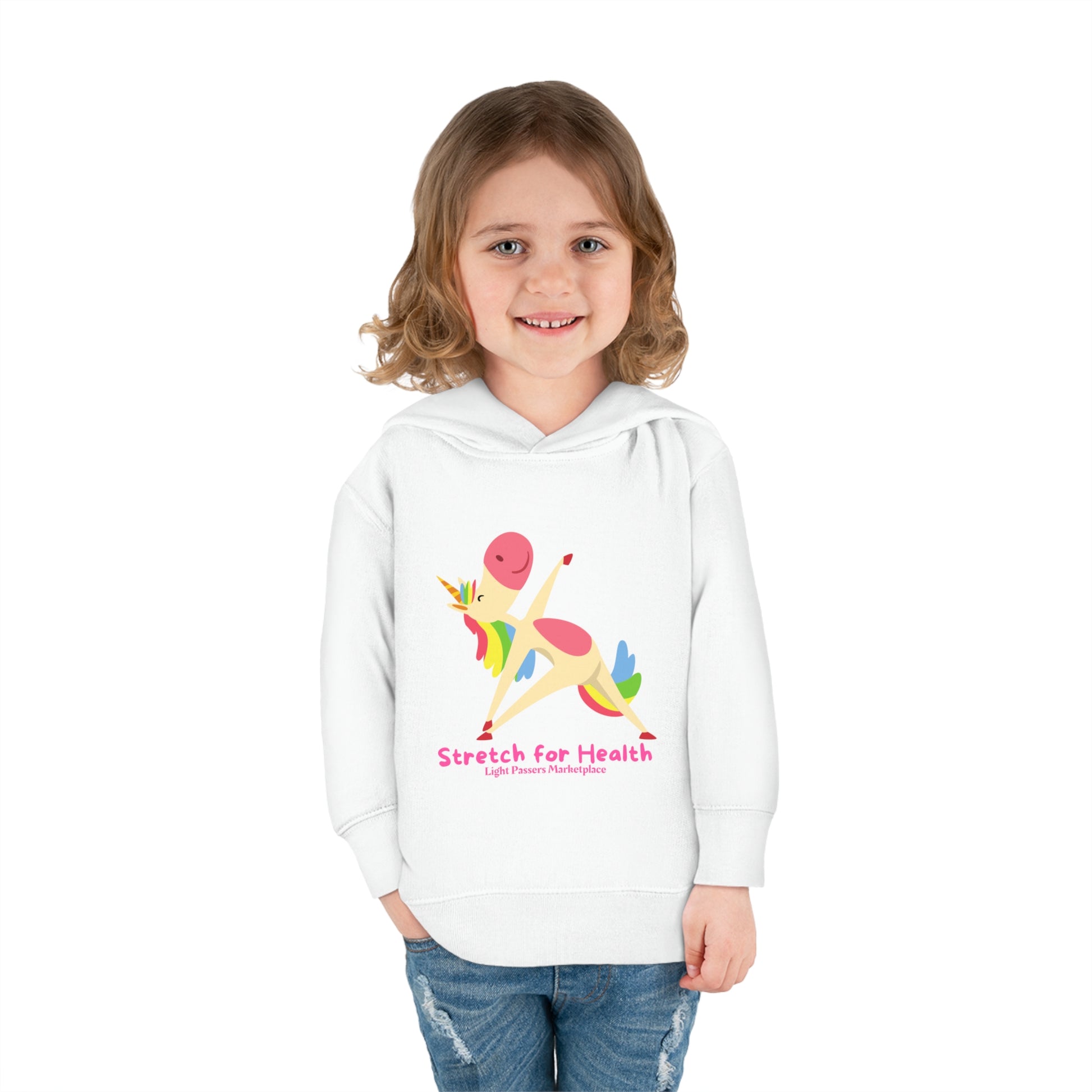 A toddler wearing a white hoodie with a unicorn design, featuring jersey-lined hood, cover-stitched details, and side seam pockets for lasting comfort.