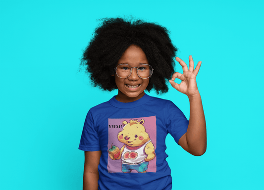 A toddler wearing glasses and a cartoon shirt, making a hand gesture. Yum Strawberries Toddler T-shirt in soft, durable cotton with a high-quality print.