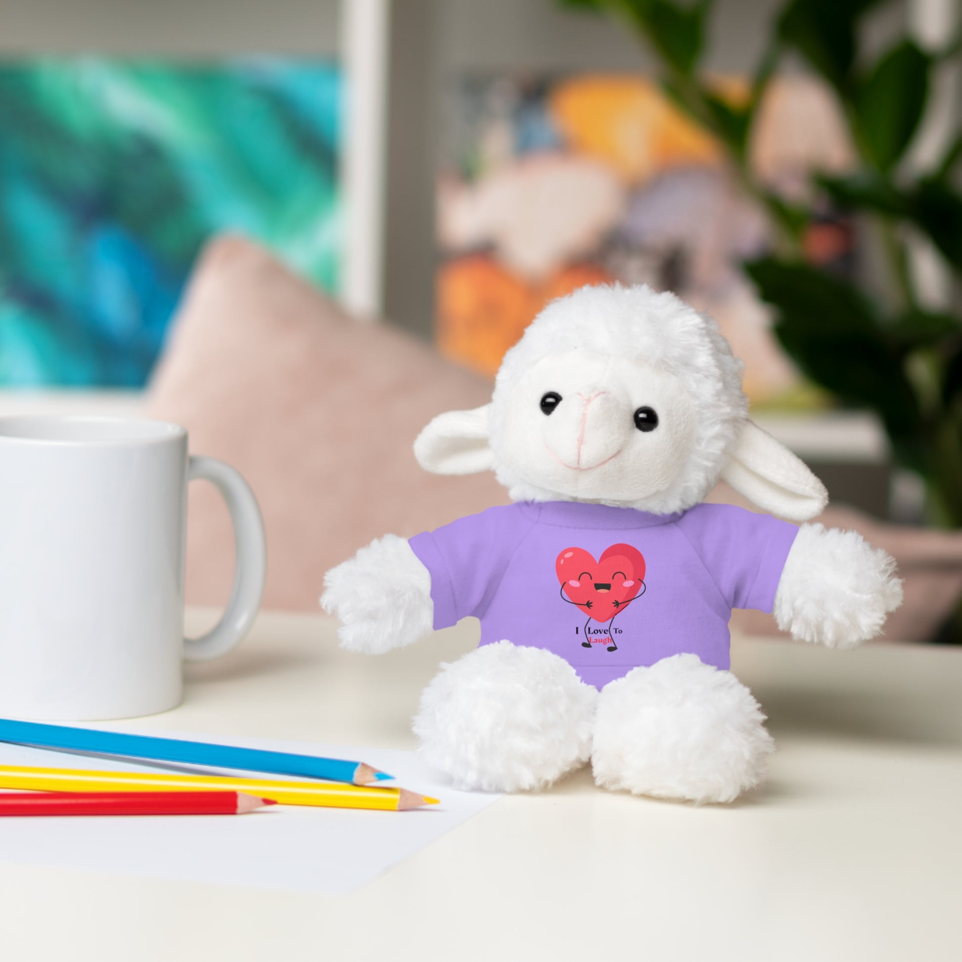 Cool Stuff Stuffies plush toy, Bunny with a removable I Love to Laugh shirt, seated on a table, perfect for gifting and cuddling.