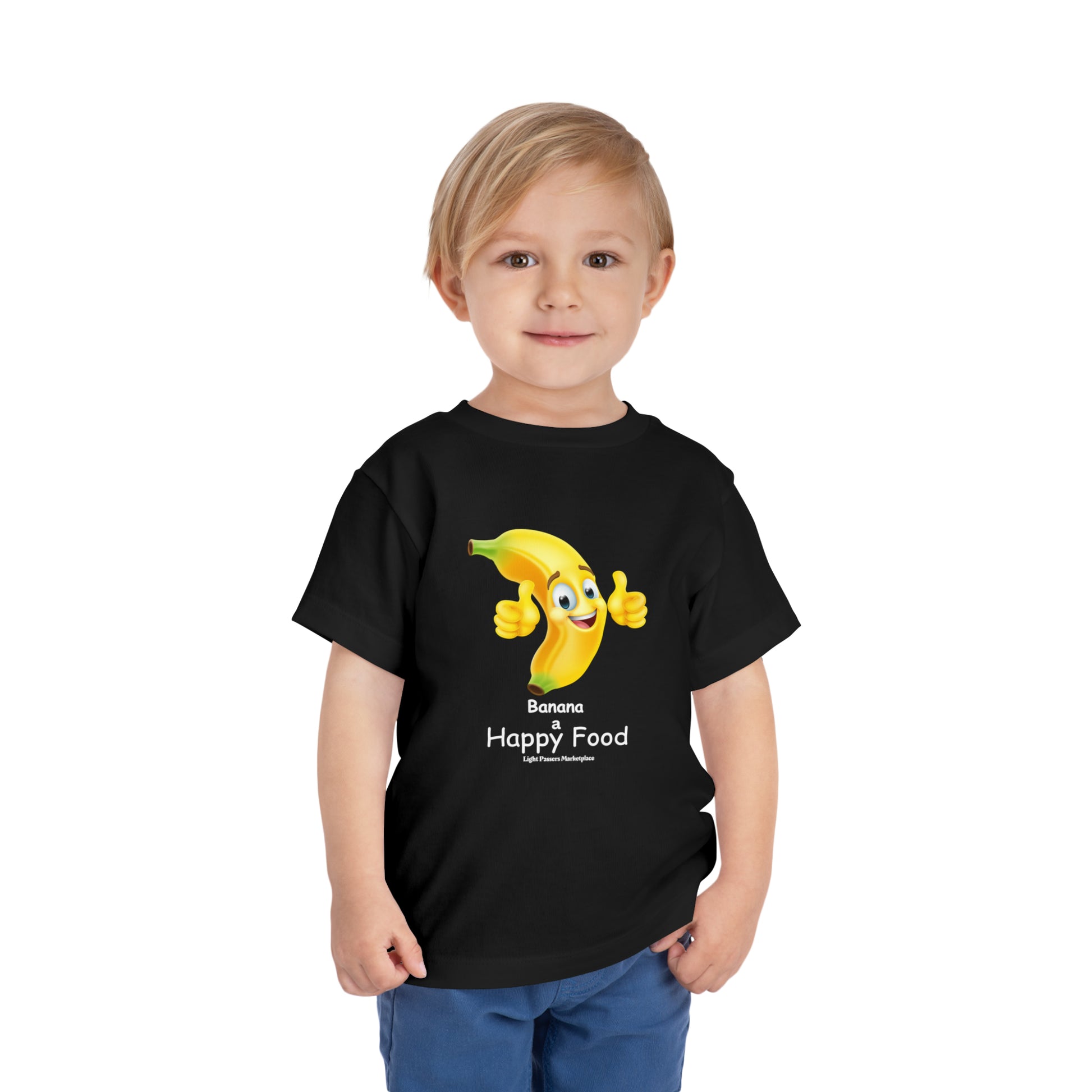 A toddler in a black shirt with a cartoon banana giving a thumbs up. Bella Canvas tee in 100% Airlume cotton, tear-away label for comfort.