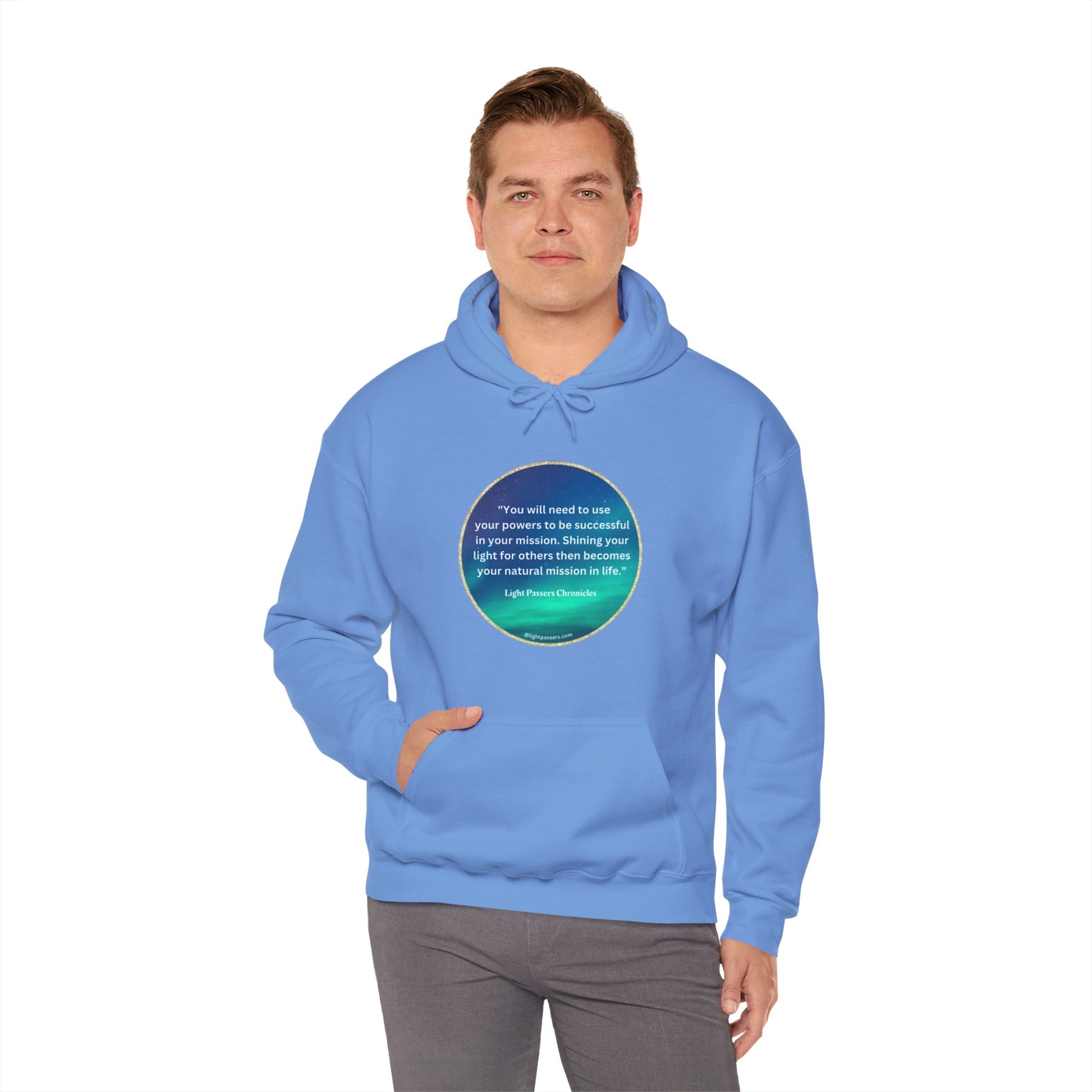 A person in a blue hooded sweatshirt with a circular design and text, showcasing a cozy and warm unisex heavy blend hoodie with a kangaroo pocket and color-matched drawstring.