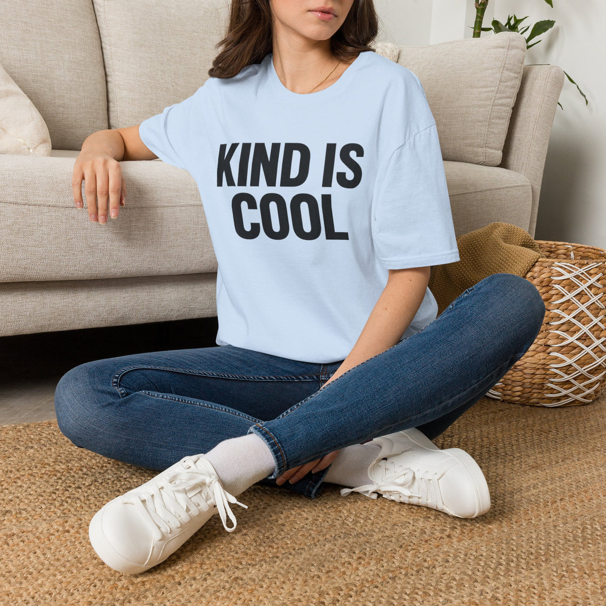 Light blue unisex T-shirt with bold text graphic reading “KIND IS COOL”