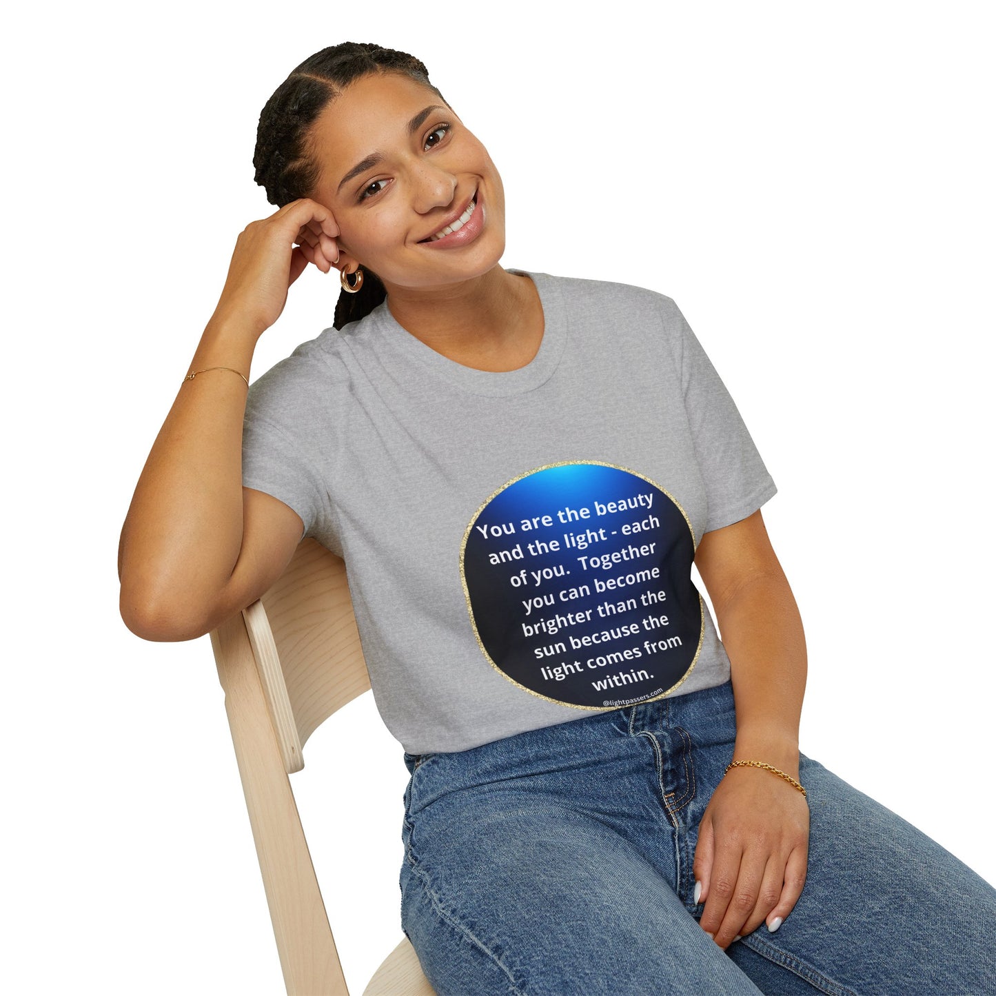 A woman in a grey shirt sits on a chair, showcasing the Beauty Navy Circle Unisex T-shirt. The image emphasizes casual fashion with a personalized design, highlighting the tee's smooth fabric and durable construction.