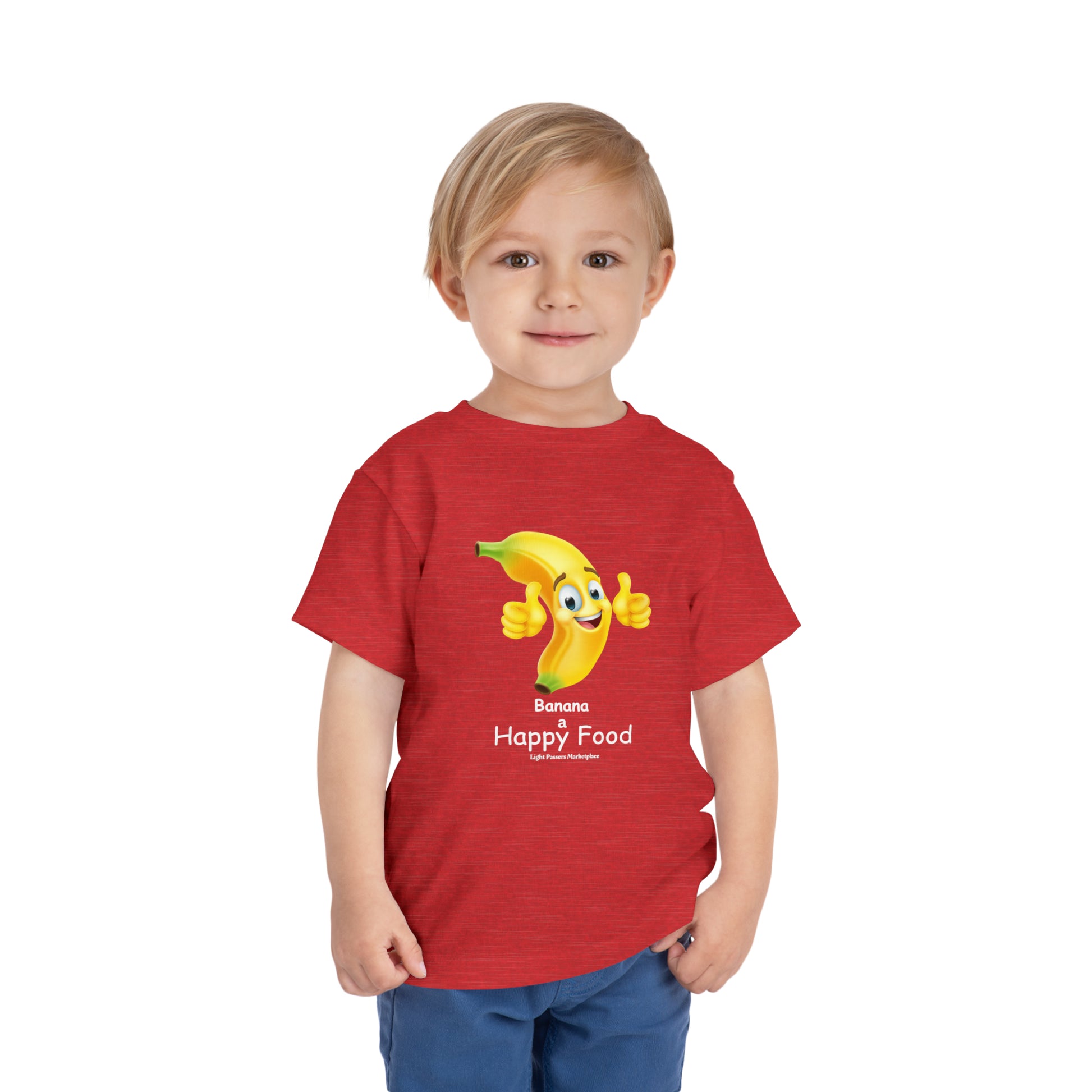 A boy in a red shirt and jeans, close-up of face, wearing a Banana Happy Food Toddler T-shirt, 100% Airlume cotton, tear-away label, perfect for everyday wear.