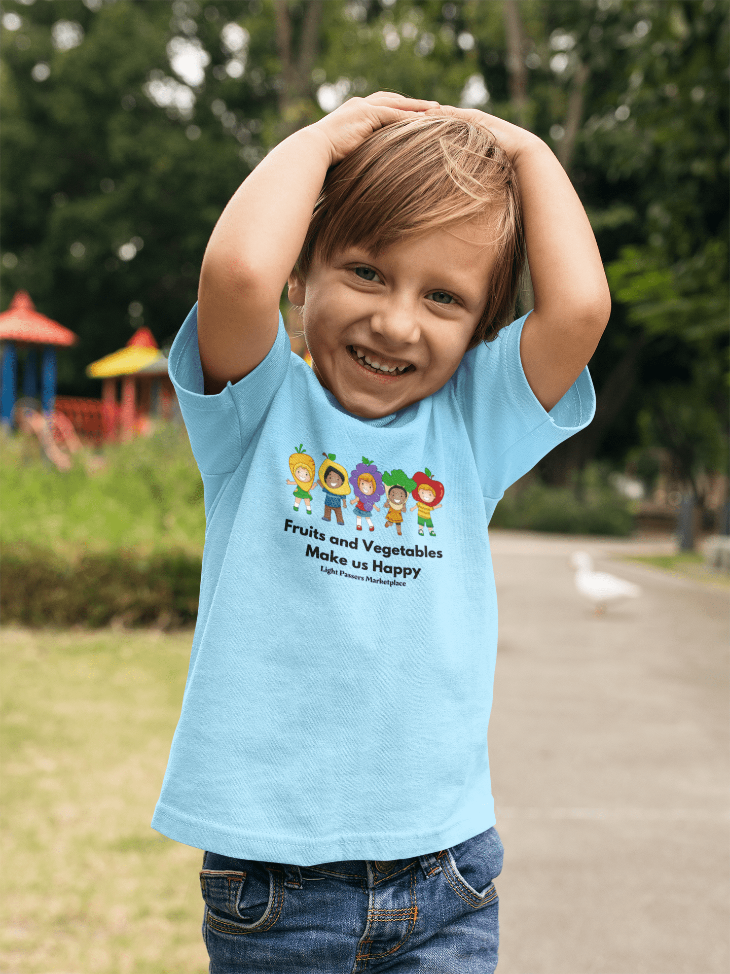 A toddler happily raises arms in a soft tee. Durable print on 100% cotton, light fabric. Perfect for sensitive skin, tear-away label, classic fit, true to size.