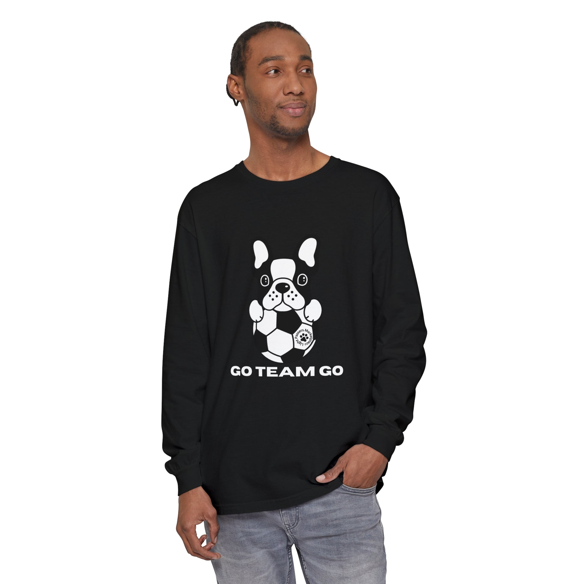 Man wearing Teams Soccer Dog Adult Unisex Garment-dyed Long Sleeve, featuring a black and white dog with a football print on the shirt.