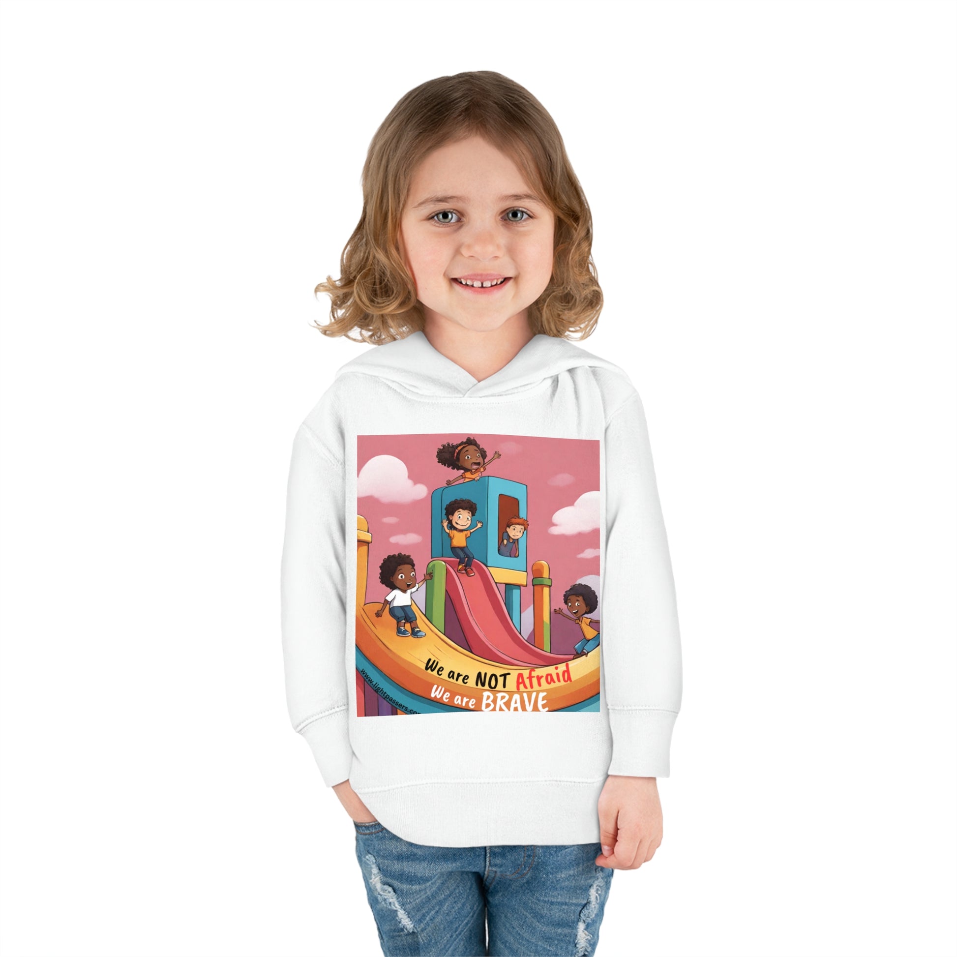 A smiling child in a white hoodie, featuring a Rabbit Skins toddler hoodie with jersey-lined hood, cover-stitched details, side seam pockets, and durable fabric blend for cozy wear.